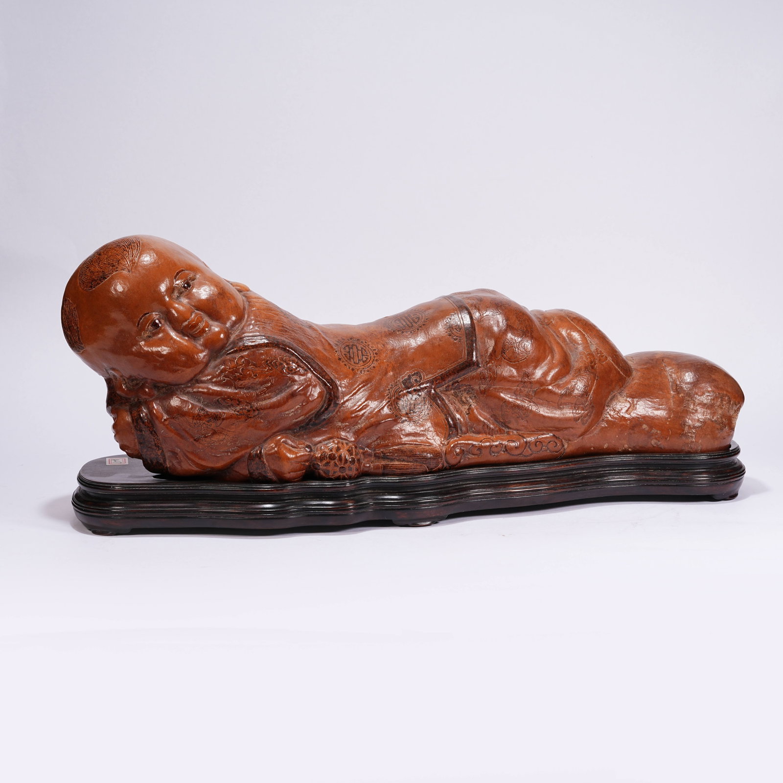 A BOXWOOD ORNAMENT OF RECLINING BOY: Boxwood Ornament of Reclining Boy