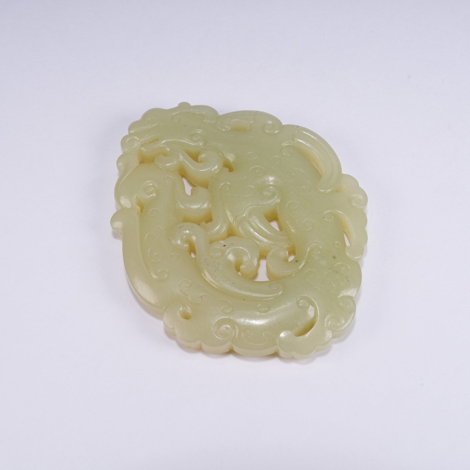 A YELLOW HETIAN JADE DRAGON PATTERN PENDANT: Yellow Hetian Jade Dragon Pattern Pendant