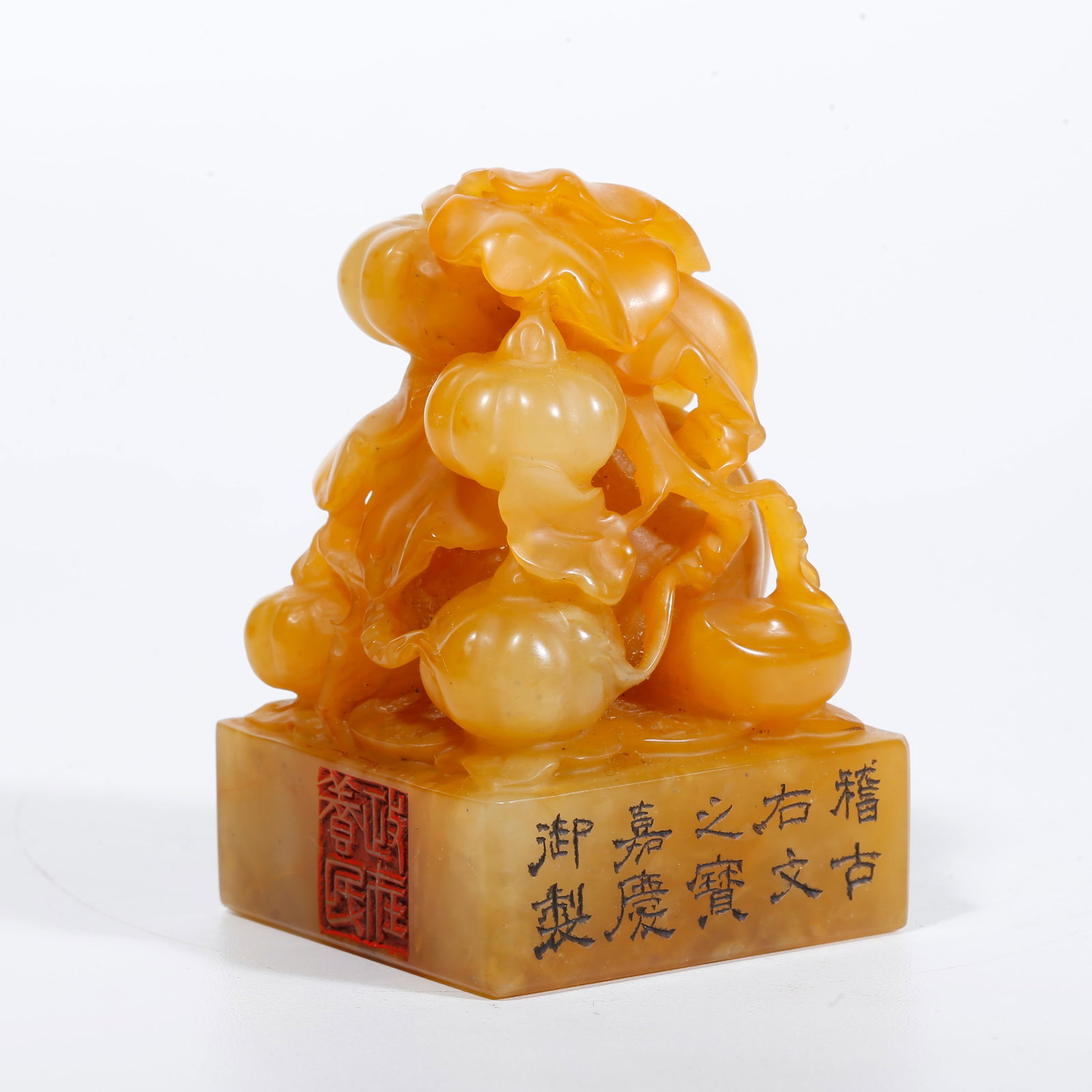 A SEAL WITH MELON AND FRUIT KNOB CARVED FROM SHOUSHAN TIANHUANG STONE: Seal with melon and fruit knob carved from Shoushan Tianhuang stone