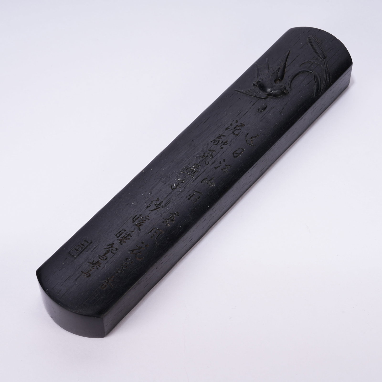 A RED SANDALWOOD PAPERWEIGHT WITH FLOWER-AND-BIRD MOTIF: Red Sandalwood Paperweight with Flower-and-Bird Motif