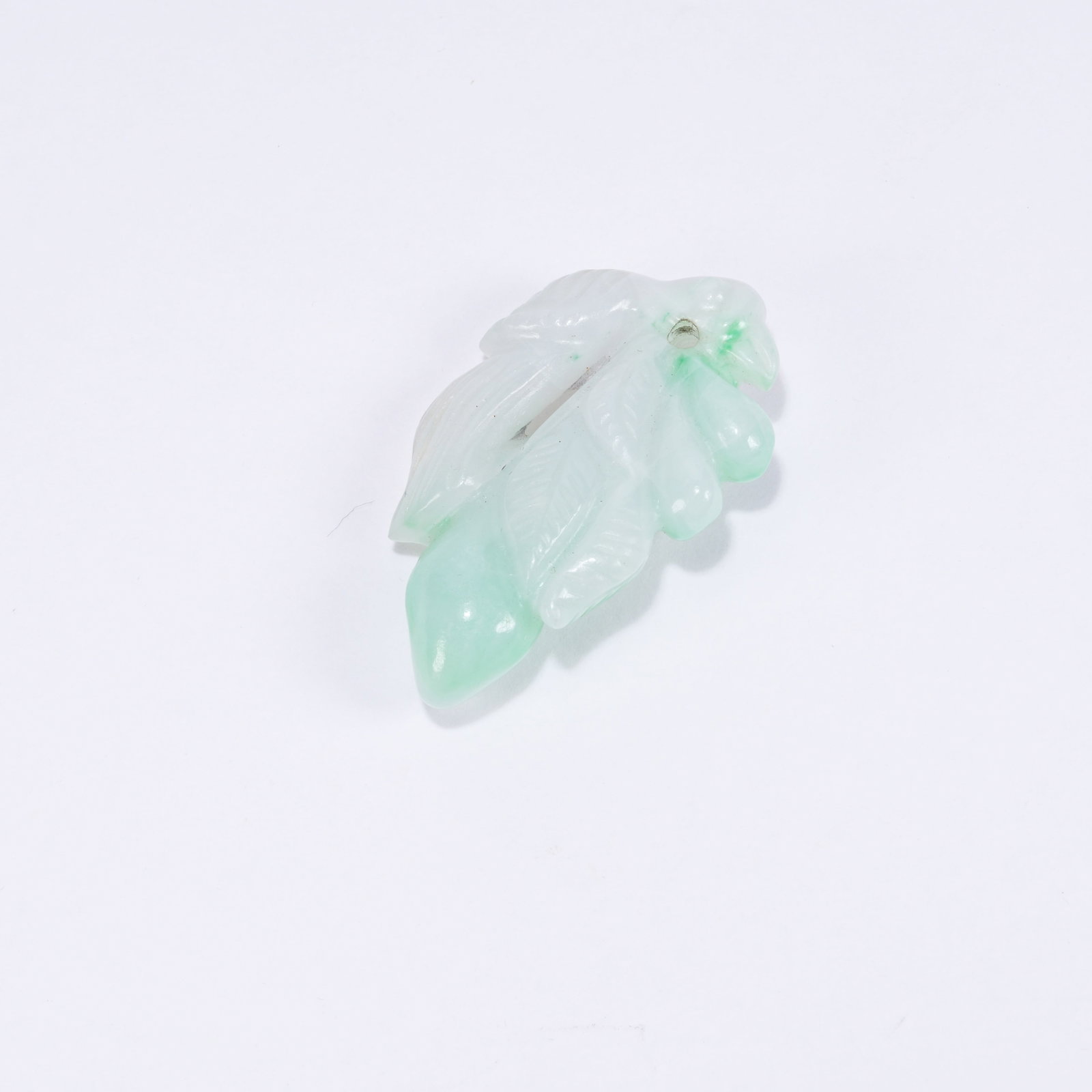 A JADEITE AUSPICIOUS FRUIT SHAPED PENDANT: Jadeite Auspicious Fruit Shaped Pendant