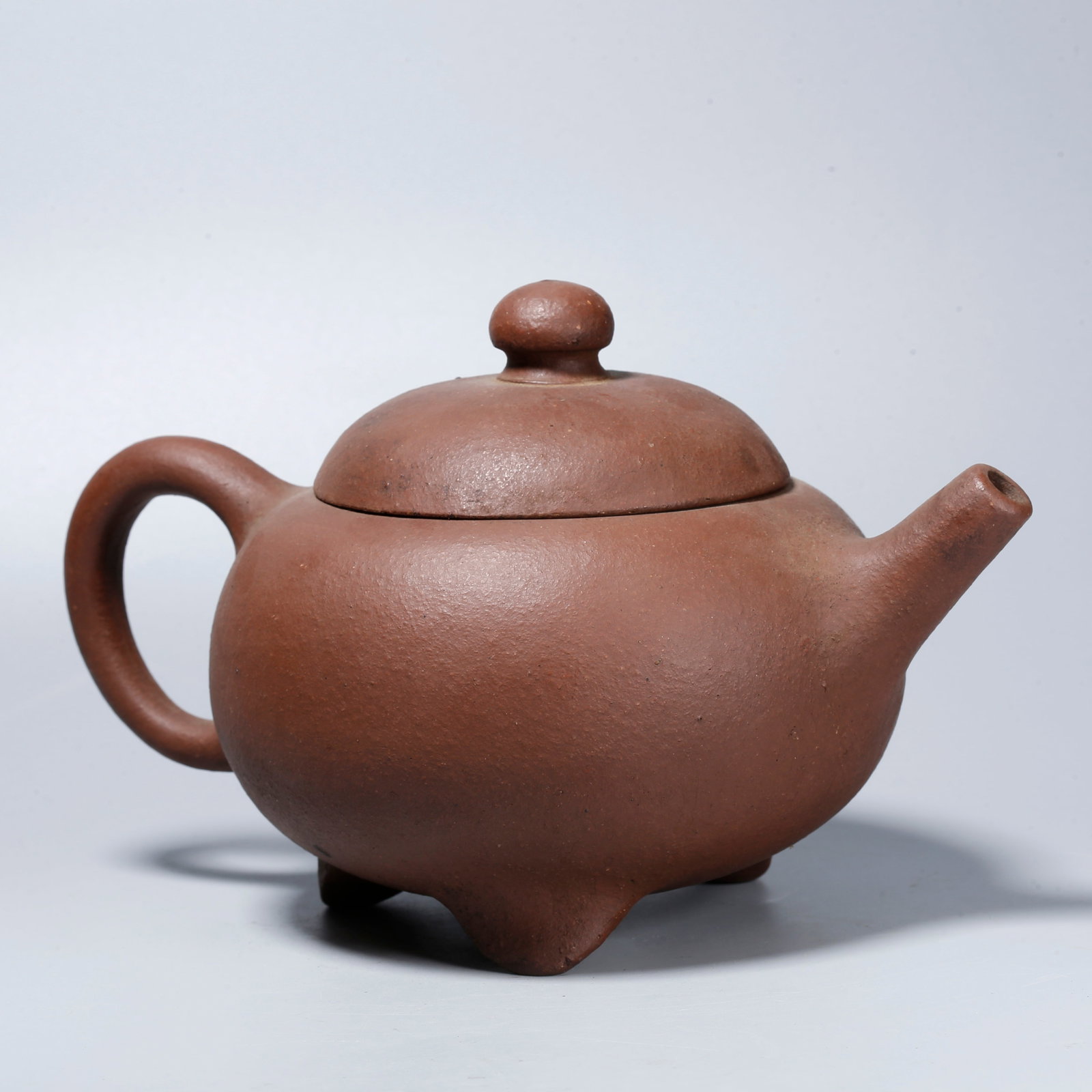 A ZISHA CARVED TRIPOD EWER: Zisha Carved Tripod Ewer