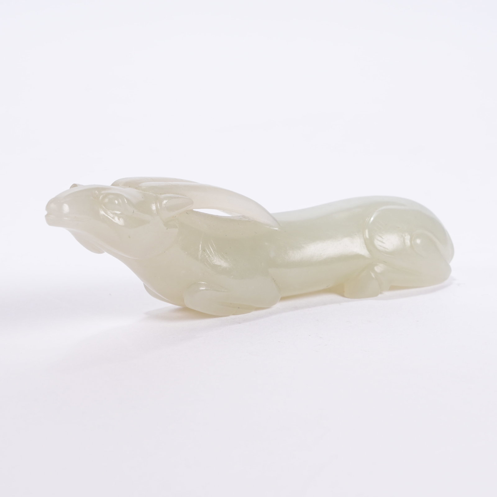 A HETIAN JADE LYING DEER ORNAMENT: Hetian Jade Lying Deer Ornament