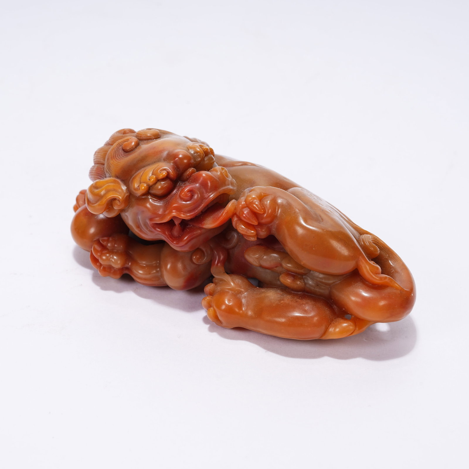 A SHOUSHAN STONE RECLINING LION HAND PIECE: Shoushan Stone Reclining Lion Hand Piece