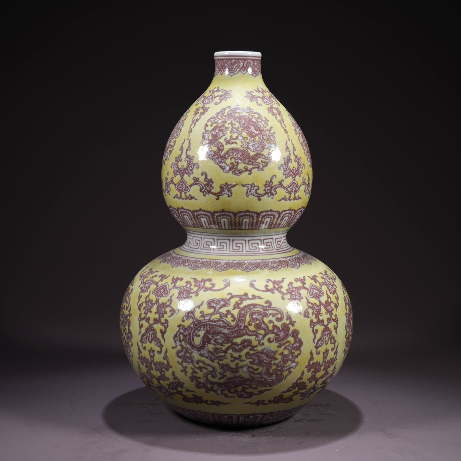 A YELLOW GROUND UNDERGLAZE-RED DOUBLE-GOURD VASE WITH DRAGON ROUNDEL MOTIF: Yellow Ground Underglaze-Red Double-Gourd Vase with Dragon Roundel Motif