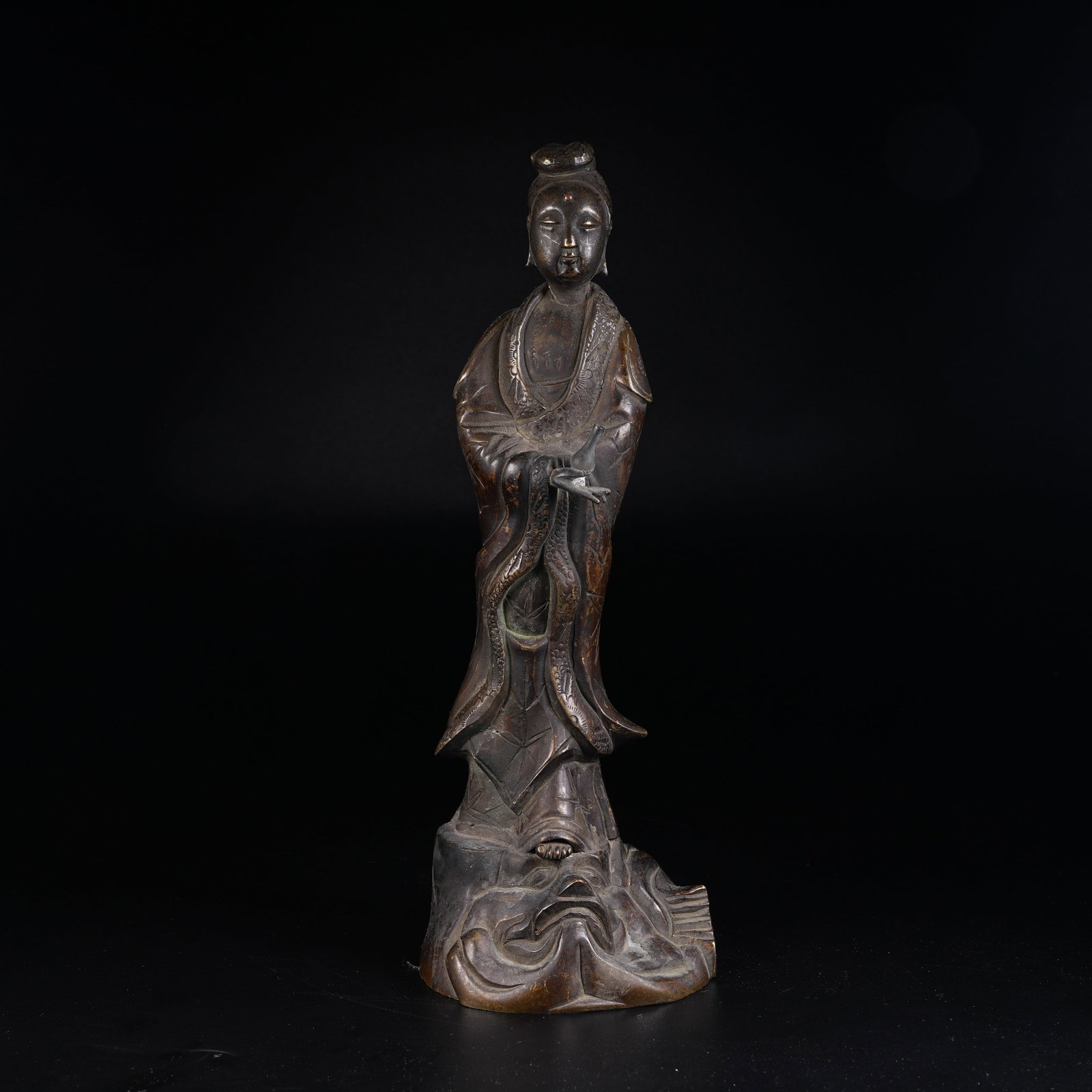 A BRONZE STANDING STATUE OF GUANYIN HOLDING VASE: Bronze Standing Statue of Guanyin Holding Vase