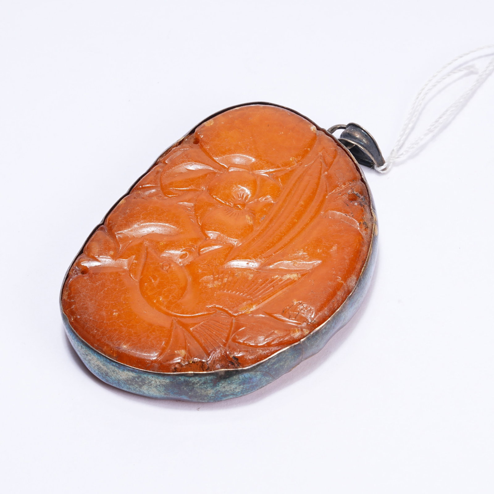 A BEESWAX FLOWER AND BIRD PATTERN PENDANT: Beeswax Flower and Bird Pattern Pendant