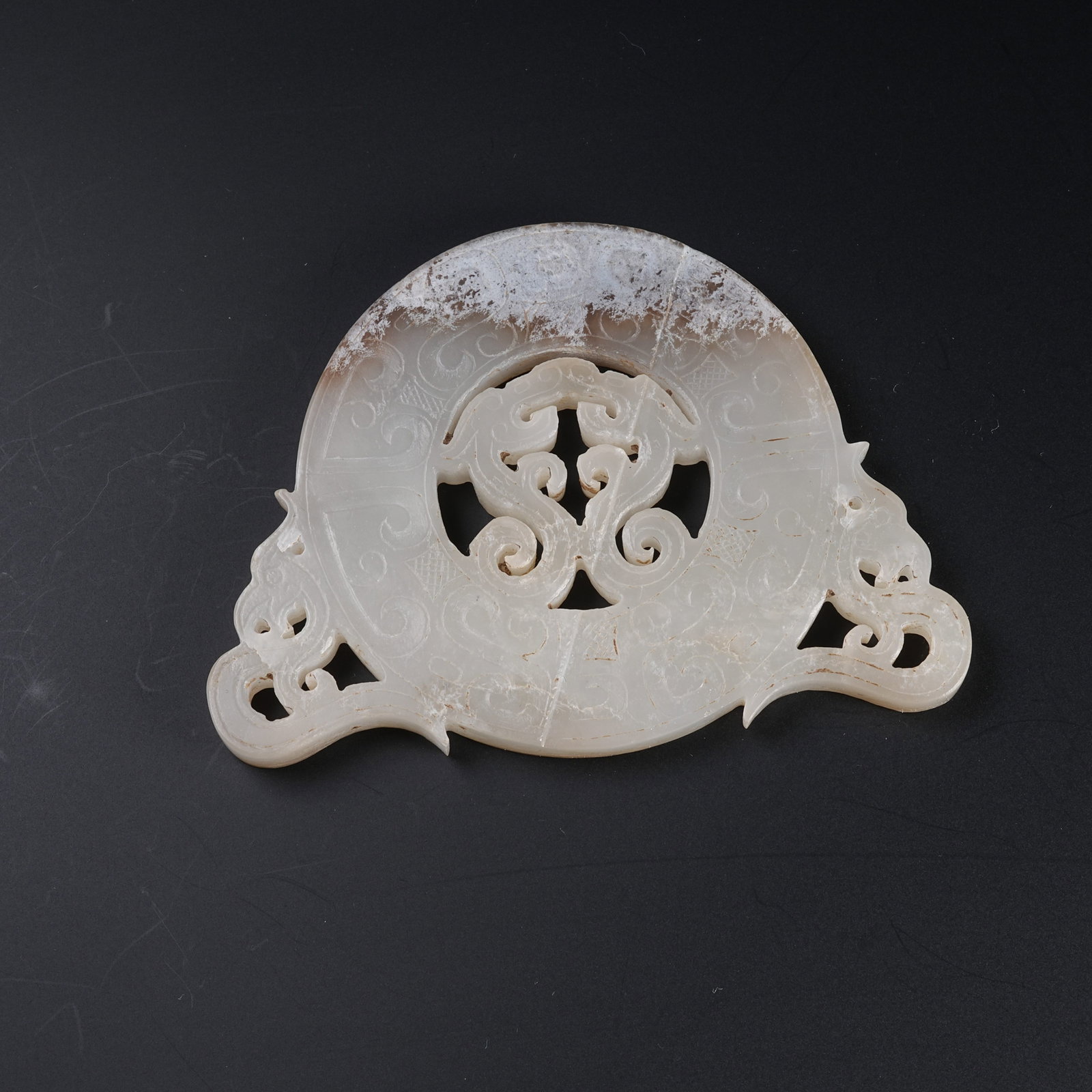A ANCIENT JADE OUTER RELIEF BI DISC WITH DRAGON PATTERNS: Ancient Jade Outer Relief Bi Disc with Dragon Patterns