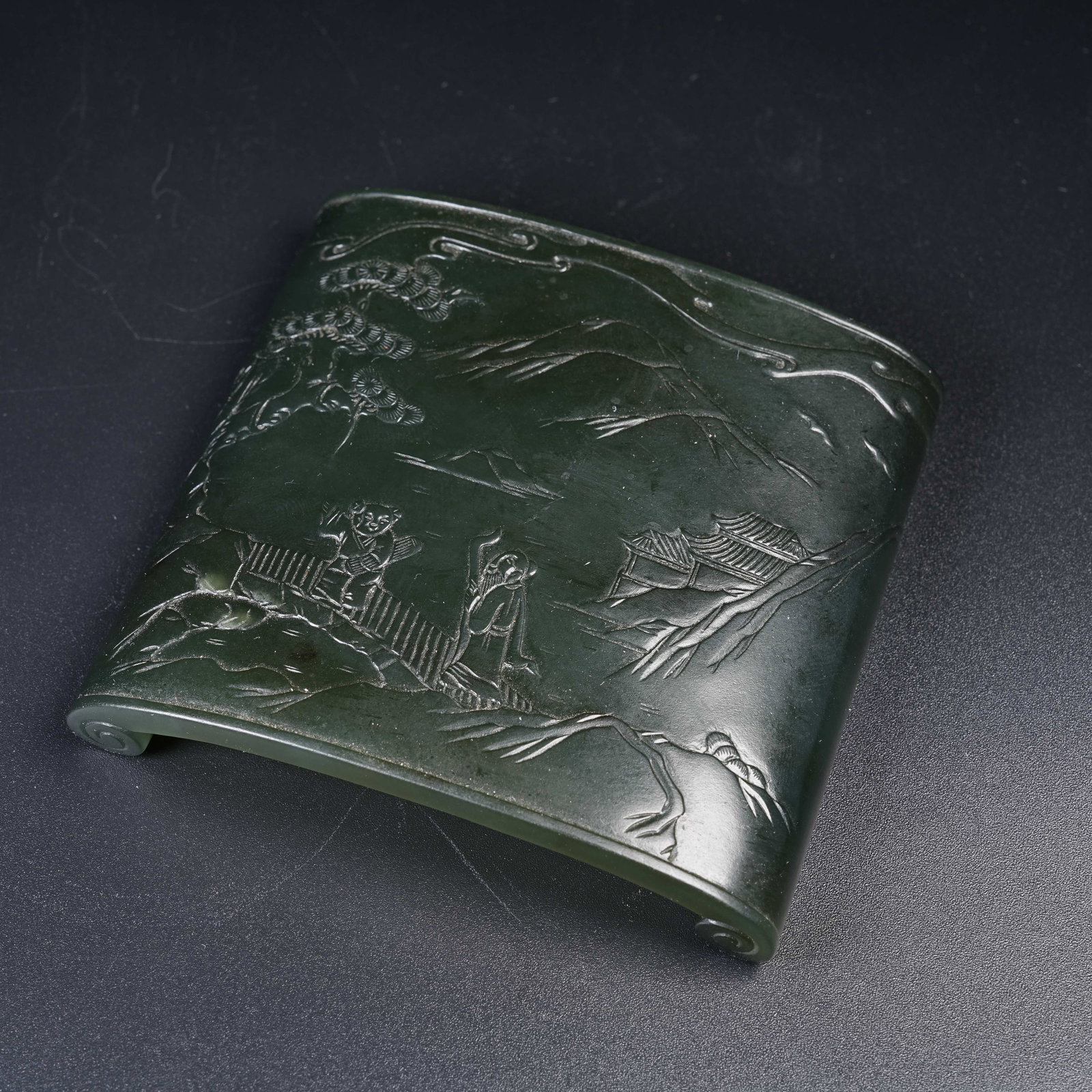 A GREEN HETIAN JADE WRIST REST WITH VISITING FRIENDS MOTIF: Green Hetian Jade Wrist Rest with Visiting Friends Motif