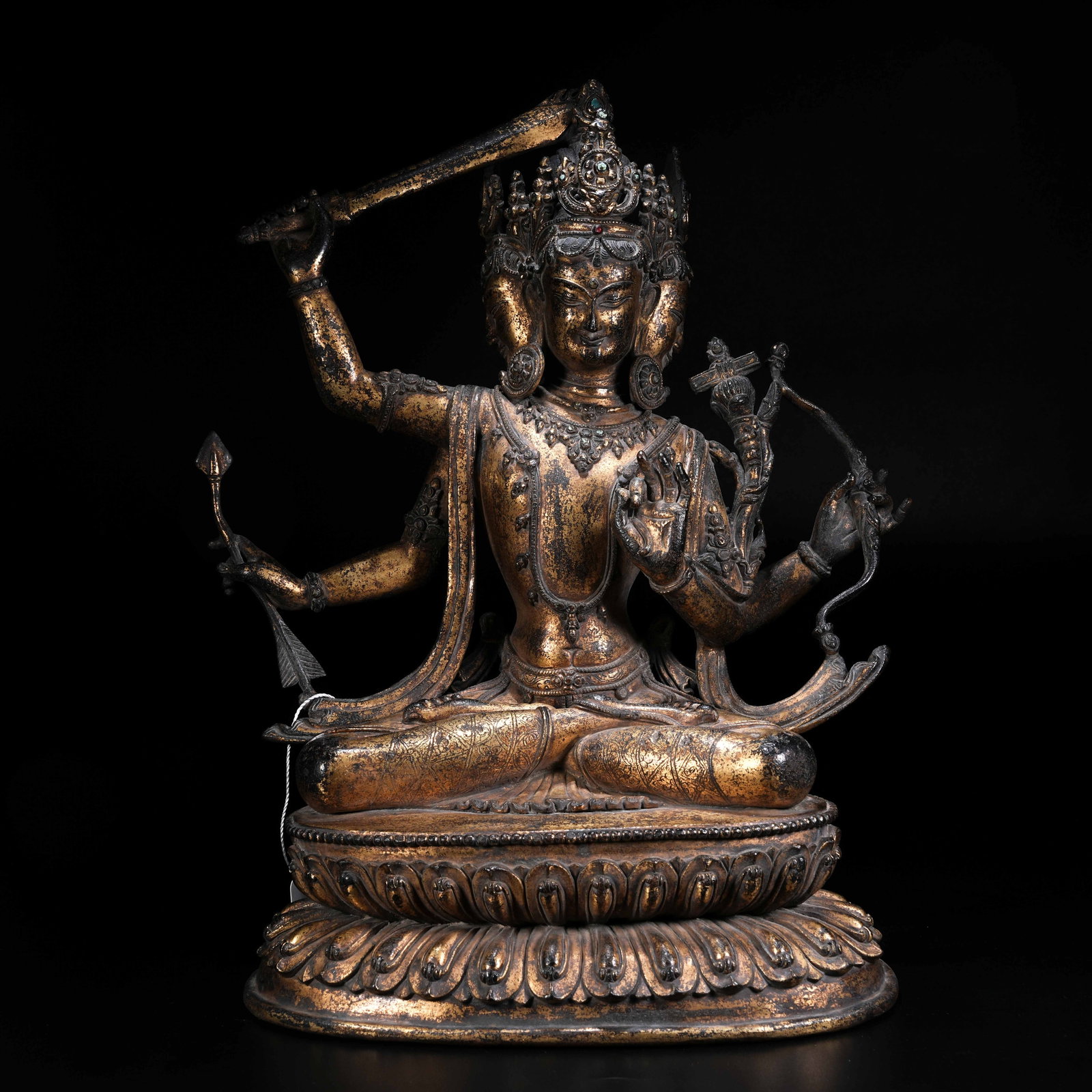 A GILT BRONZE STATUE OF MANJUSHRI WITH DHARMA BOUNDARY DECORATIONS: Gilt Bronze Statue of Manjushri with Dharma Boundary Decorations
