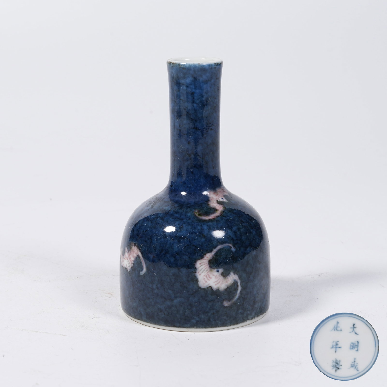 A BELL-SHAPED ZUN VASE WITH IRON-RED TEN THOUSAND BLESSINGS PATTERNS RESERVED ON BLUE GROUND: Bell-shaped Zun Vase with Iron-red Ten Thousand Blessings Patterns Reserved on Blue Ground