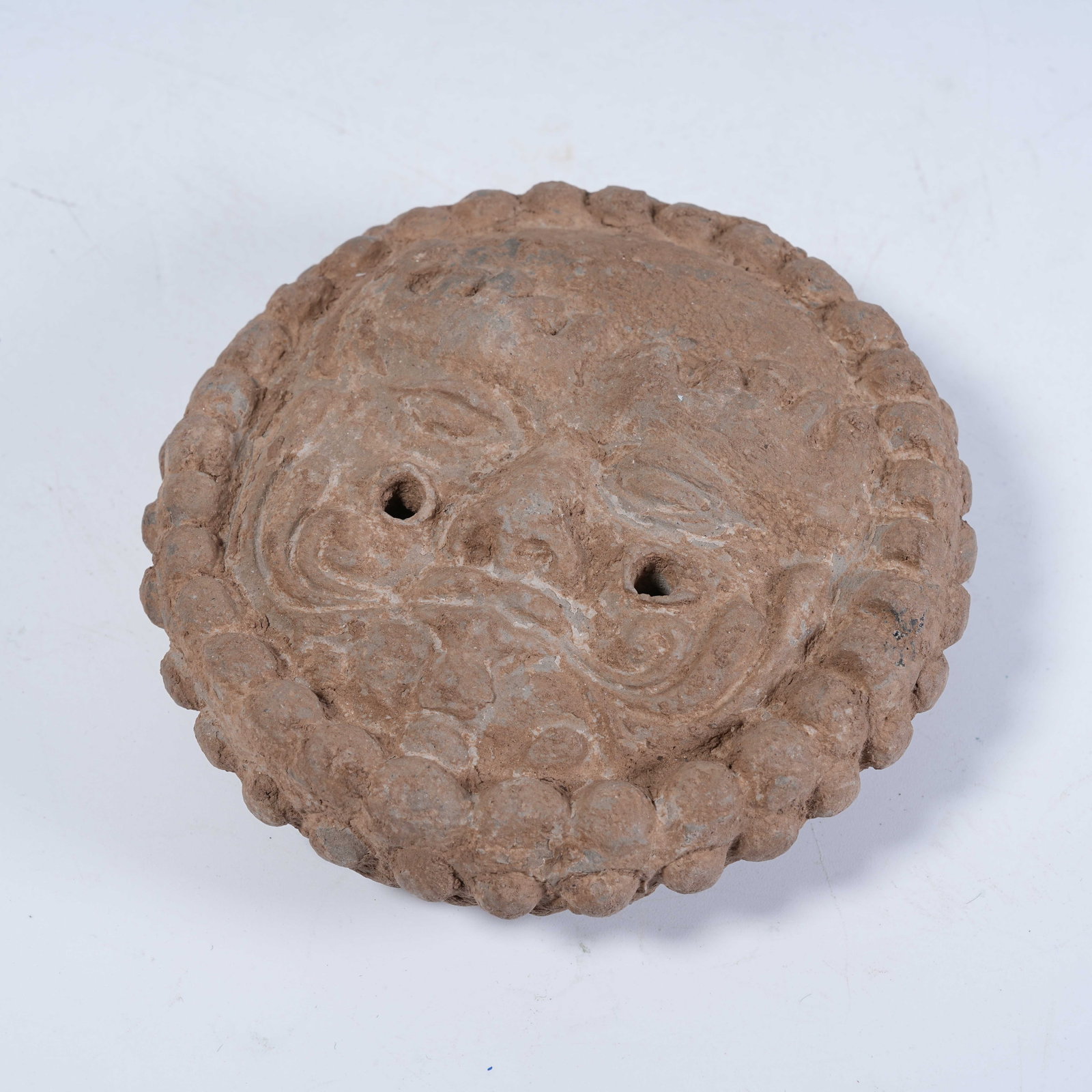 A POTTERY EAVES TILE WITH HUMAN FACE PATTERN - 10