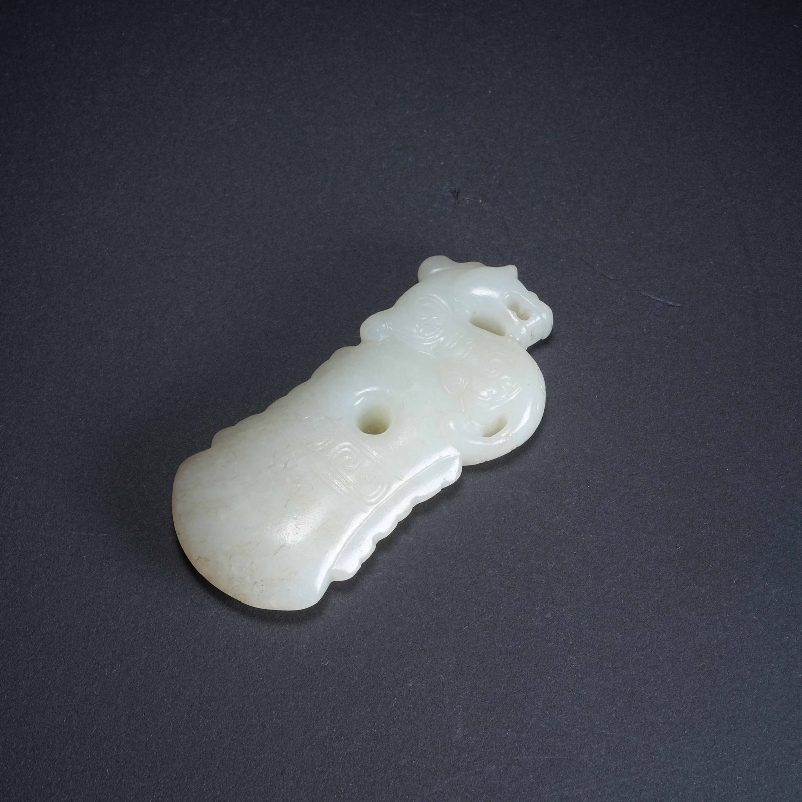 A HETIAN JADE PENDANT WITH DRAGON MOTIF: Hetian Jade Pendant with Dragon Motif