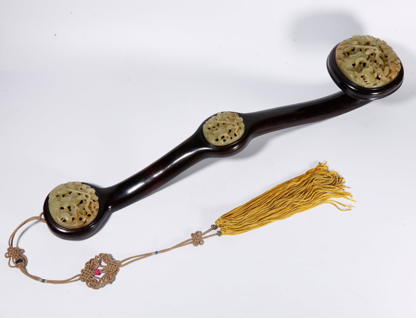 A SANDALWOOD RUYI INLAID WITH HETIAN TOPAZ CARVED WITH FIGURE STORY PATTERNS: Sandalwood Ruyi Inlaid with Hetian Topaz Carved with Figure Story Patterns