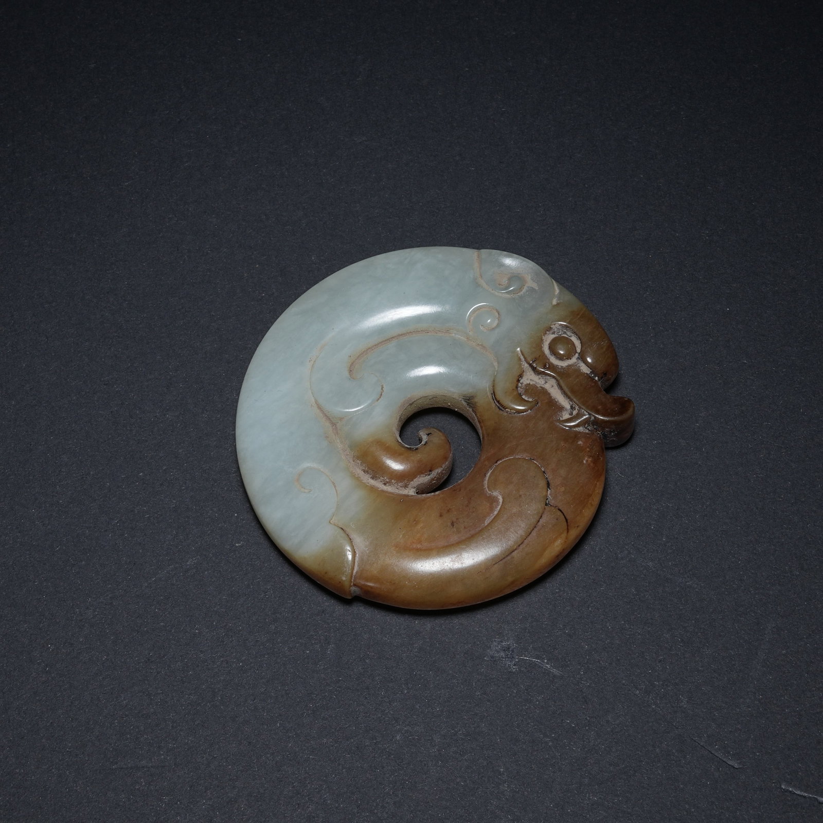 A ANCIENT JADE BI DISC WITH COILED DRAGON PATTERN OF LIANGZHU CULTURE: Ancient Jade Bi Disc with Coiled Dragon Pattern of Liangzhu Culture