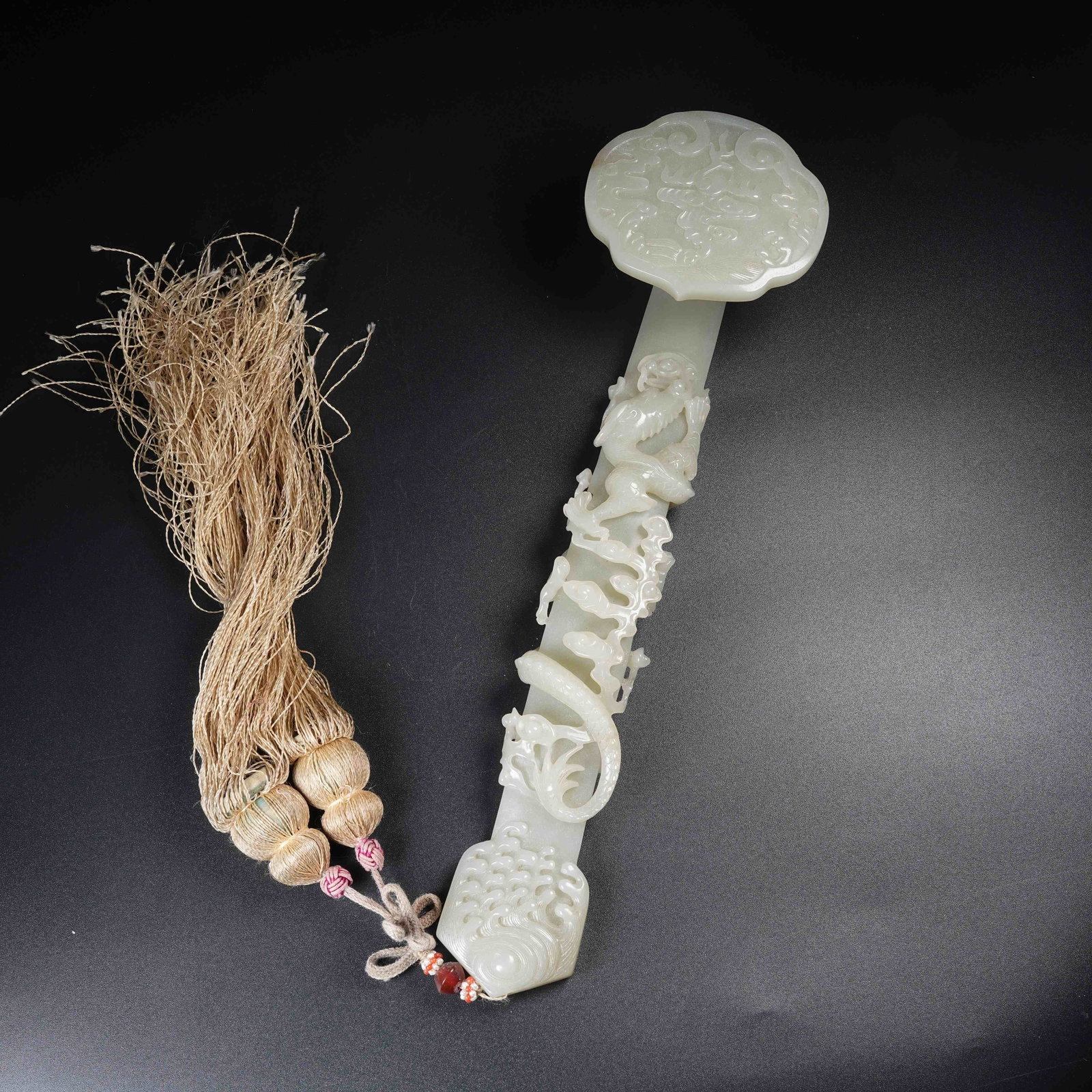 A HETIAN JADE RUYI CARVED WITH DRAGON PATTERN: Hetian Jade Ruyi Carved with Dragon Pattern