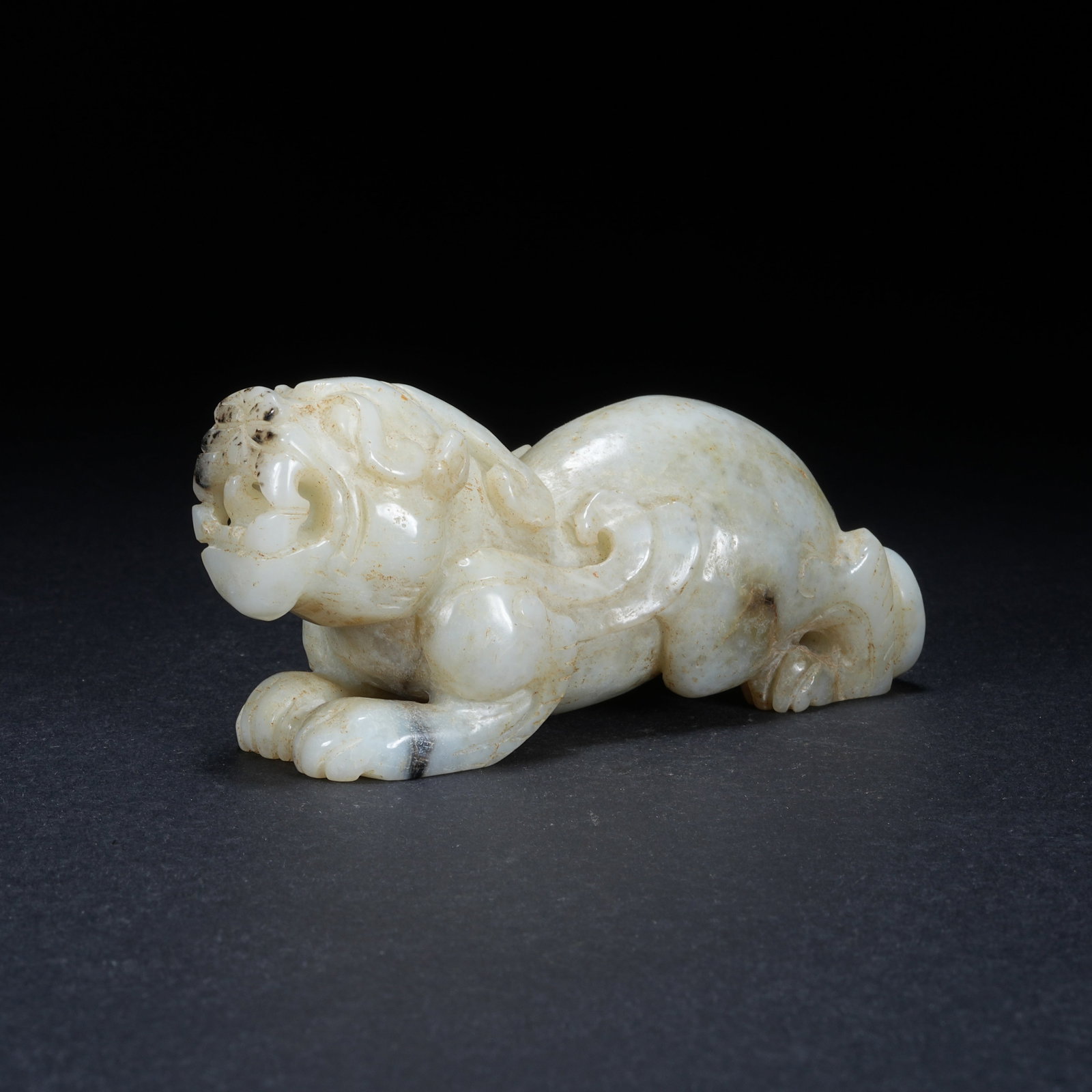 A HETIAN JADE SKILLFULLY COLORED AUSPICIOUS BEAST: Hetian Jade Skillfully Colored Auspicious Beast