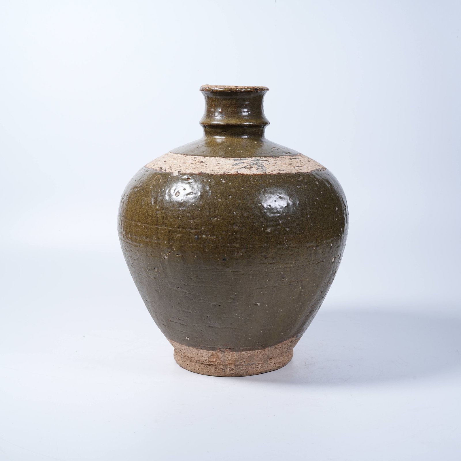 A TEA-DUST GLAZE WINE JAR: Tea-Dust Glaze Wine Jar