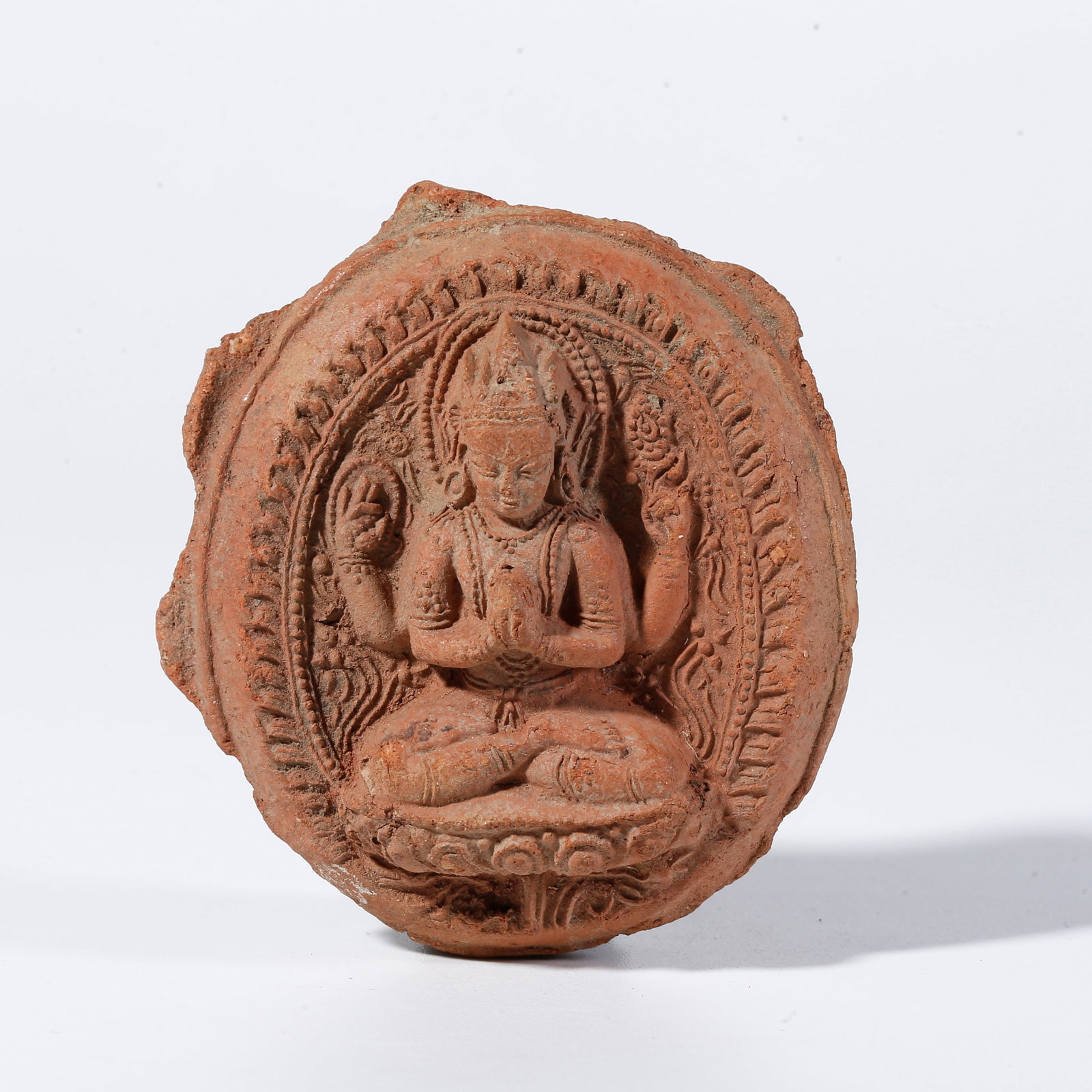 A FOUR-ARMED AVALOKITESHVARA CLAY FIGURINE: Four-Armed Avalokiteshvara Clay Figurine