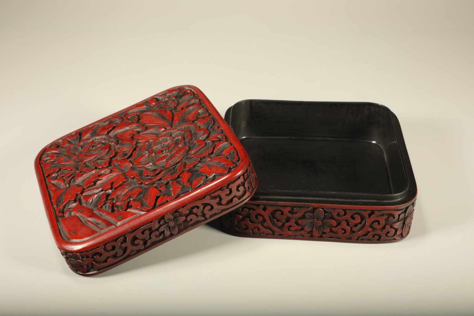 A SQUARE LACQUERED LIDDED BOX PAINTED WITH PEONY FLORAL PATTERNS: Square Lacquered Lidded Box Painted with Peony Floral Patterns