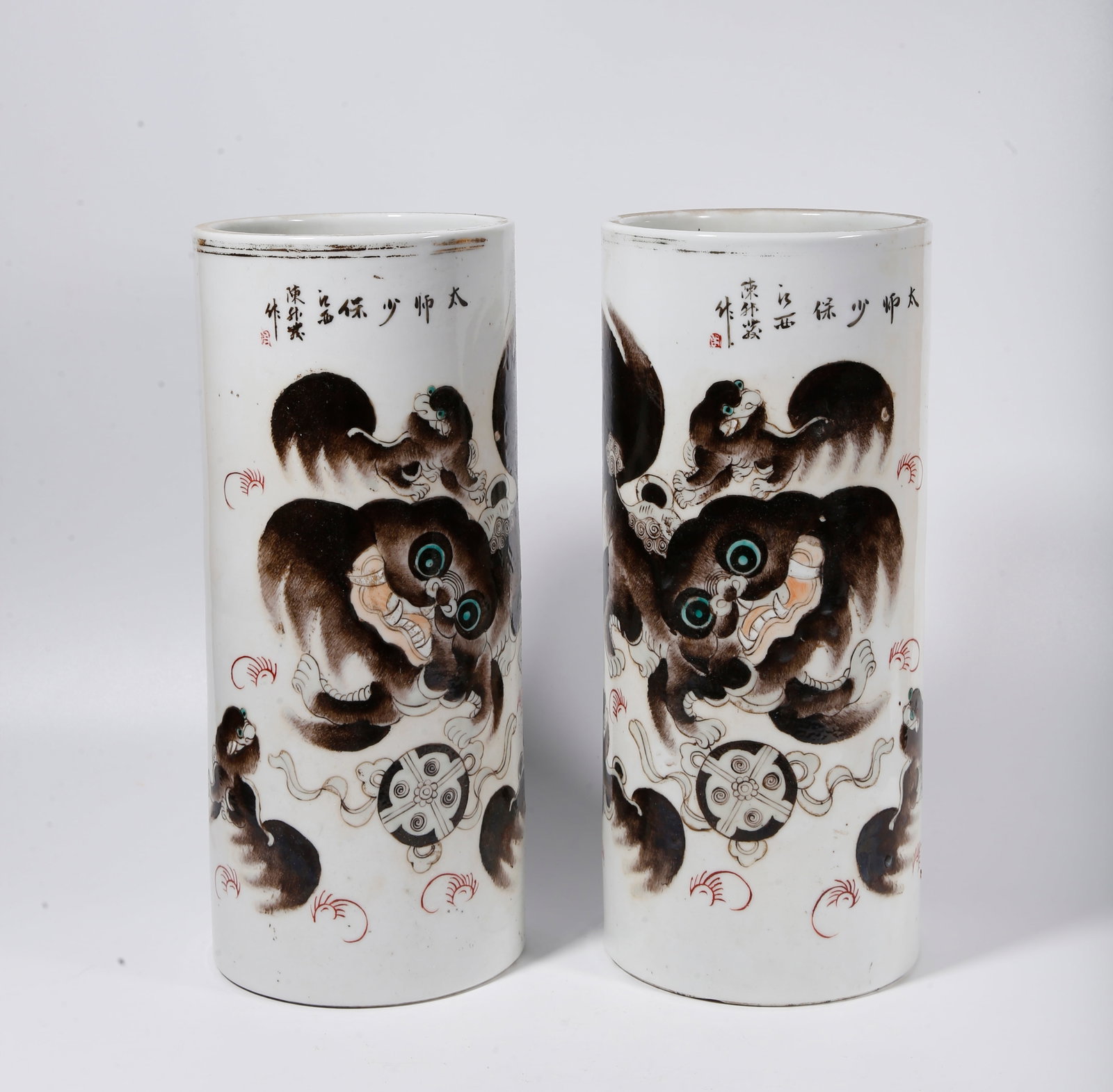 A PAIR OF FAMILLE ROSE HAT TUBES WITH LIONS PLAYING BALL PATTERN: Pair of Famille Rose Hat Tubes with Lions Playing Ball Pattern