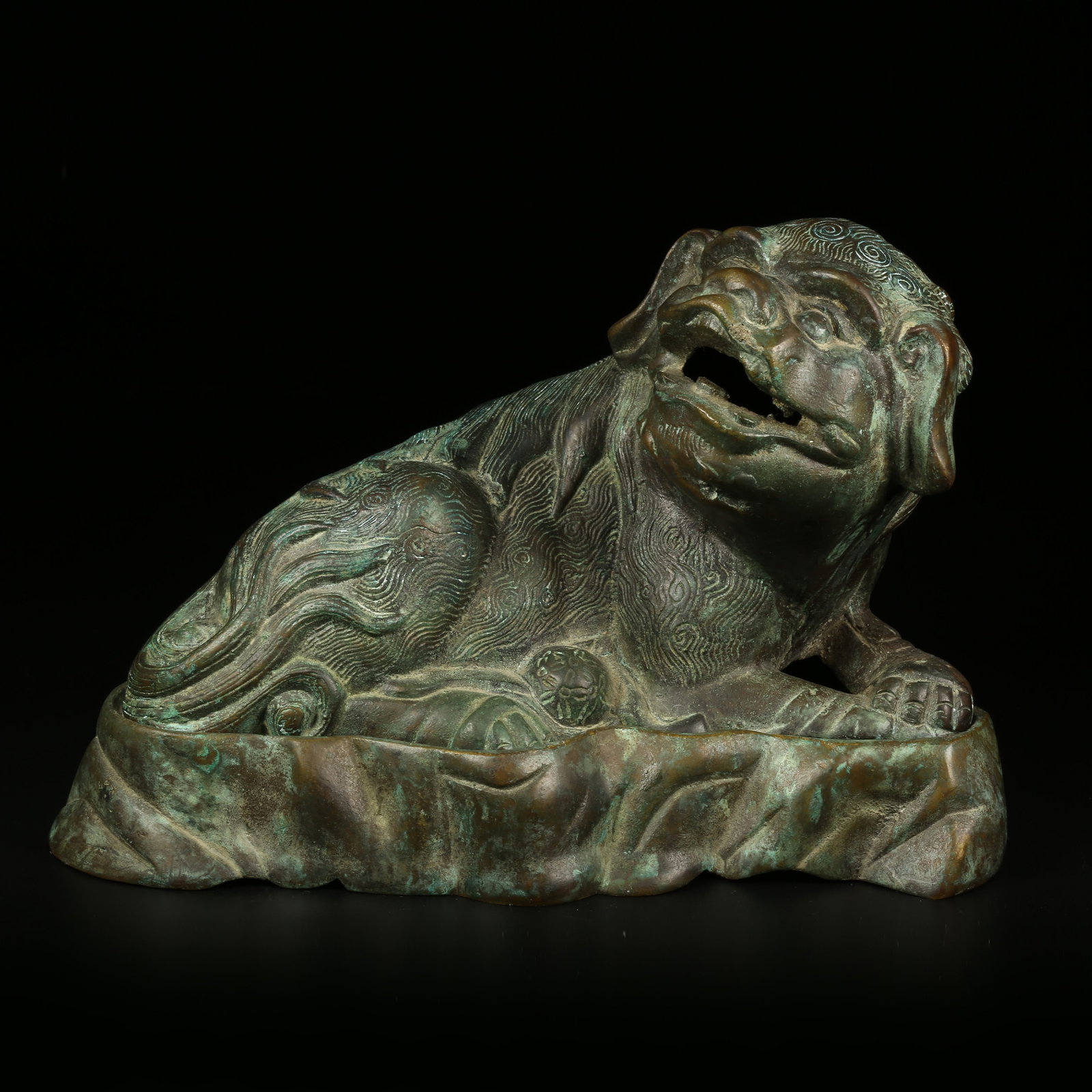 A BRONZE AUSPICIOUS LION ORNAMENT: Bronze Auspicious Lion Ornament