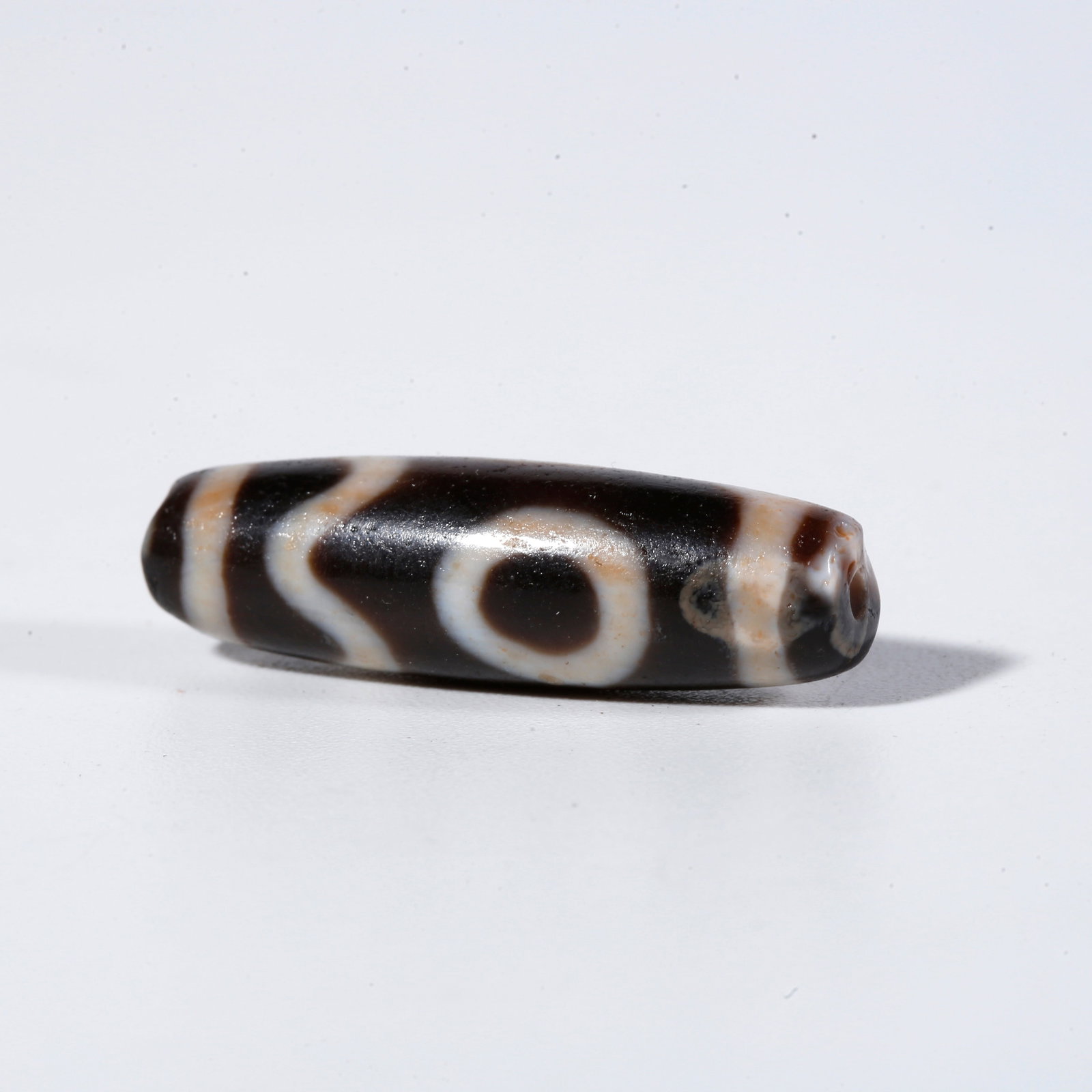 A ONE-EYED DZI BEAD: One-Eyed Dzi Bead