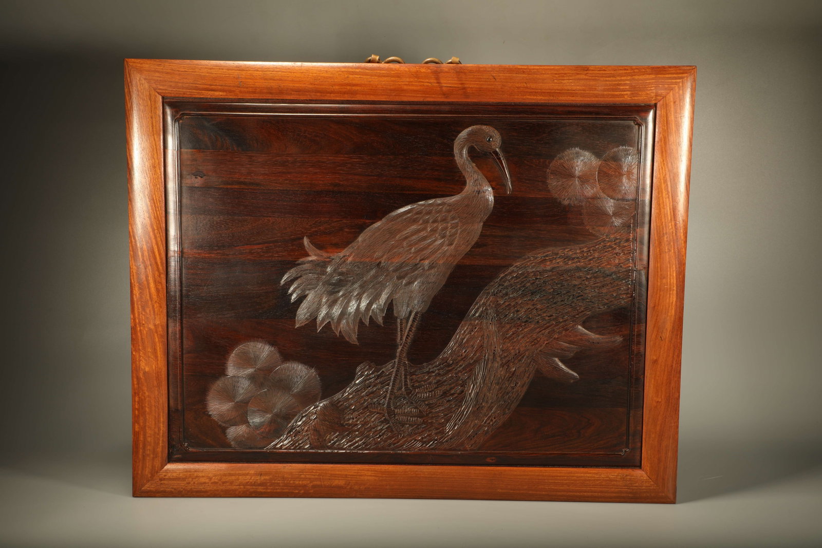 A HUANGHUALI WOOD HANGING SCREEN INLAID WITH ZITAN WOOD AND CARVED PINE AND CRANE PATTERNS (1 of 6)