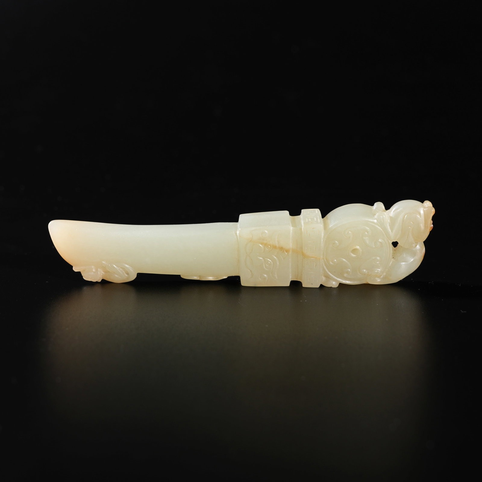 A HETIAN JADE CARVED BEAST-MASK–MOTIF PENDANT: Hetian Jade Carved Beast-Mask–Motif Pendant