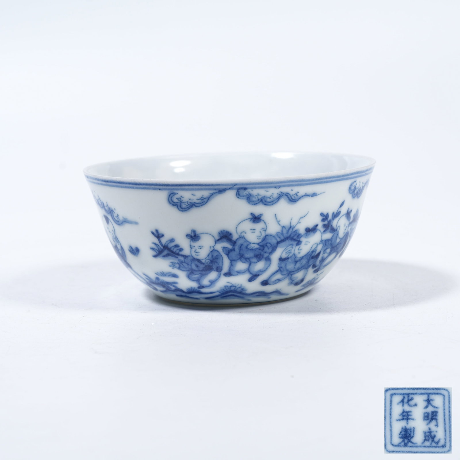 A BLUE AND WHITE CUP WITH CHILDREN AT PLAY MOTIFS (1 of 9)