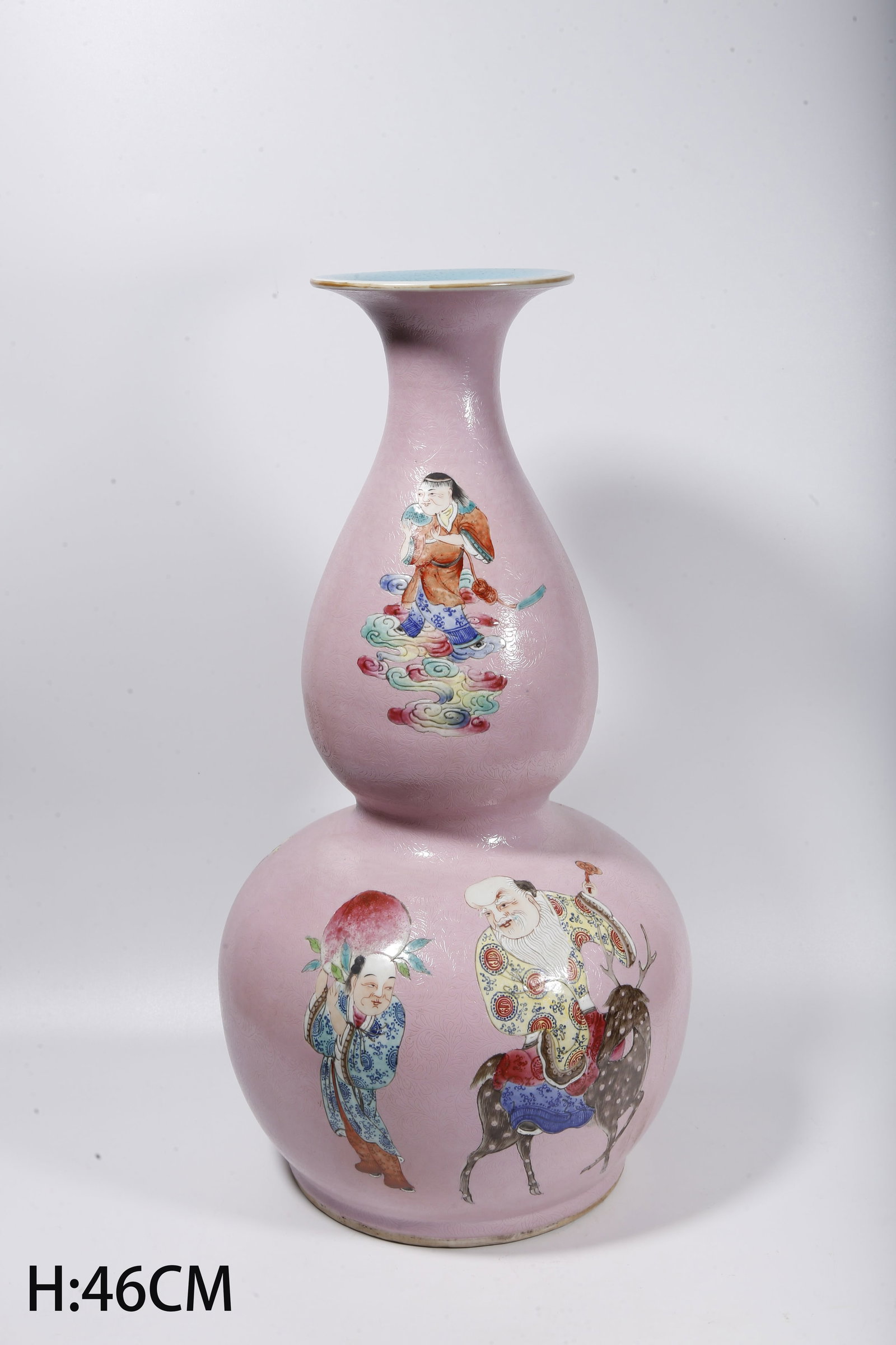 A CRIMSON GROUND INCISED FAMILLE ROSE GOURD VASE WITH FIGURE STORY SCENES: Crimson Ground Incised Famille Rose Gourd Vase with Figure Story Scenes
