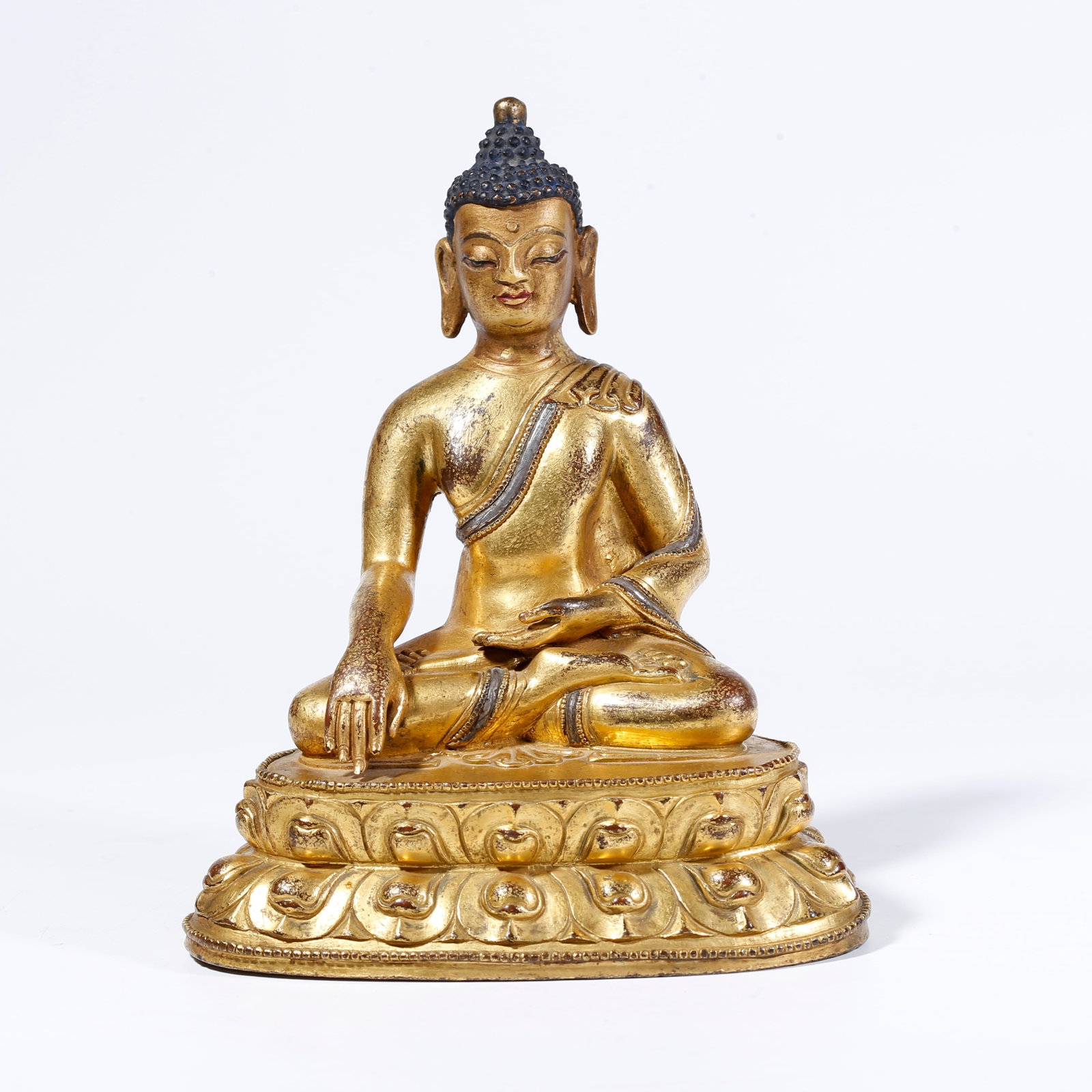 A GILT-BRONZE SHAKYAMUNI BUDDHA FIGURE: Gilt-Bronze Shakyamuni Buddha Figure