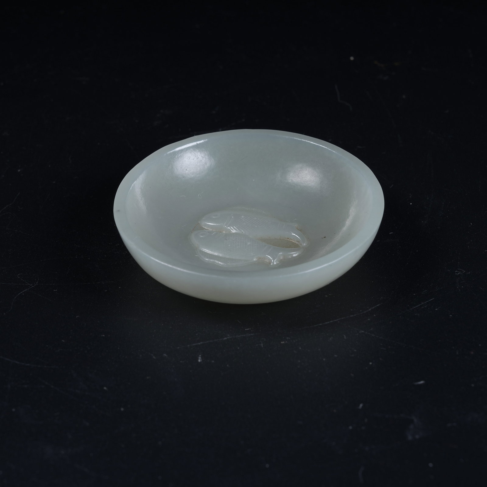A HETIAN JADE WASHER CARVED WITH DOUBLE FISH MOTIFS: Hetian Jade Washer Carved with Double Fish Motifs