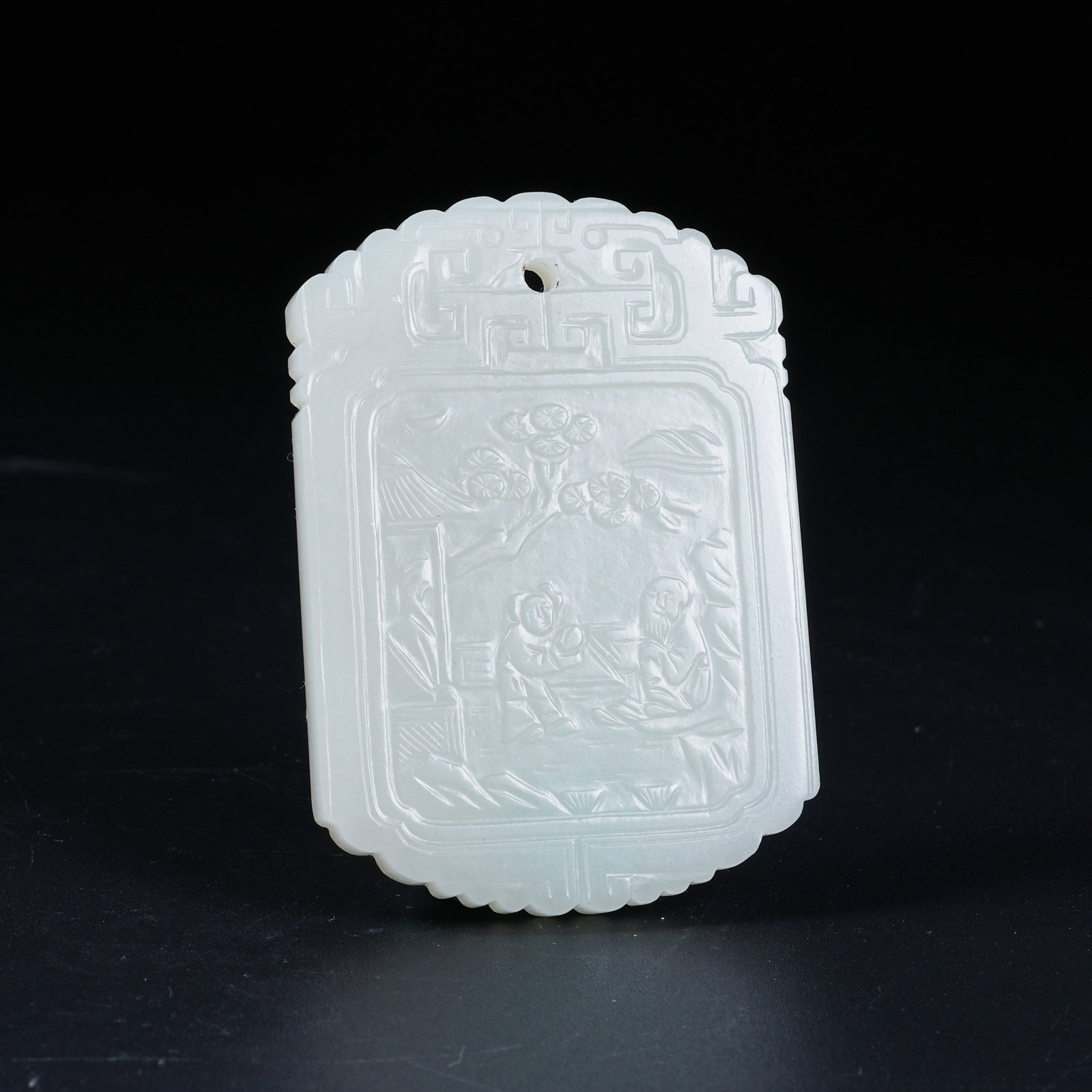 A HETIAN WHITE JADE PENDANT WITH SCENE OF SCHOLARS UNDER PINES: Hetian White Jade Pendant with Scene of Scholars Under Pines