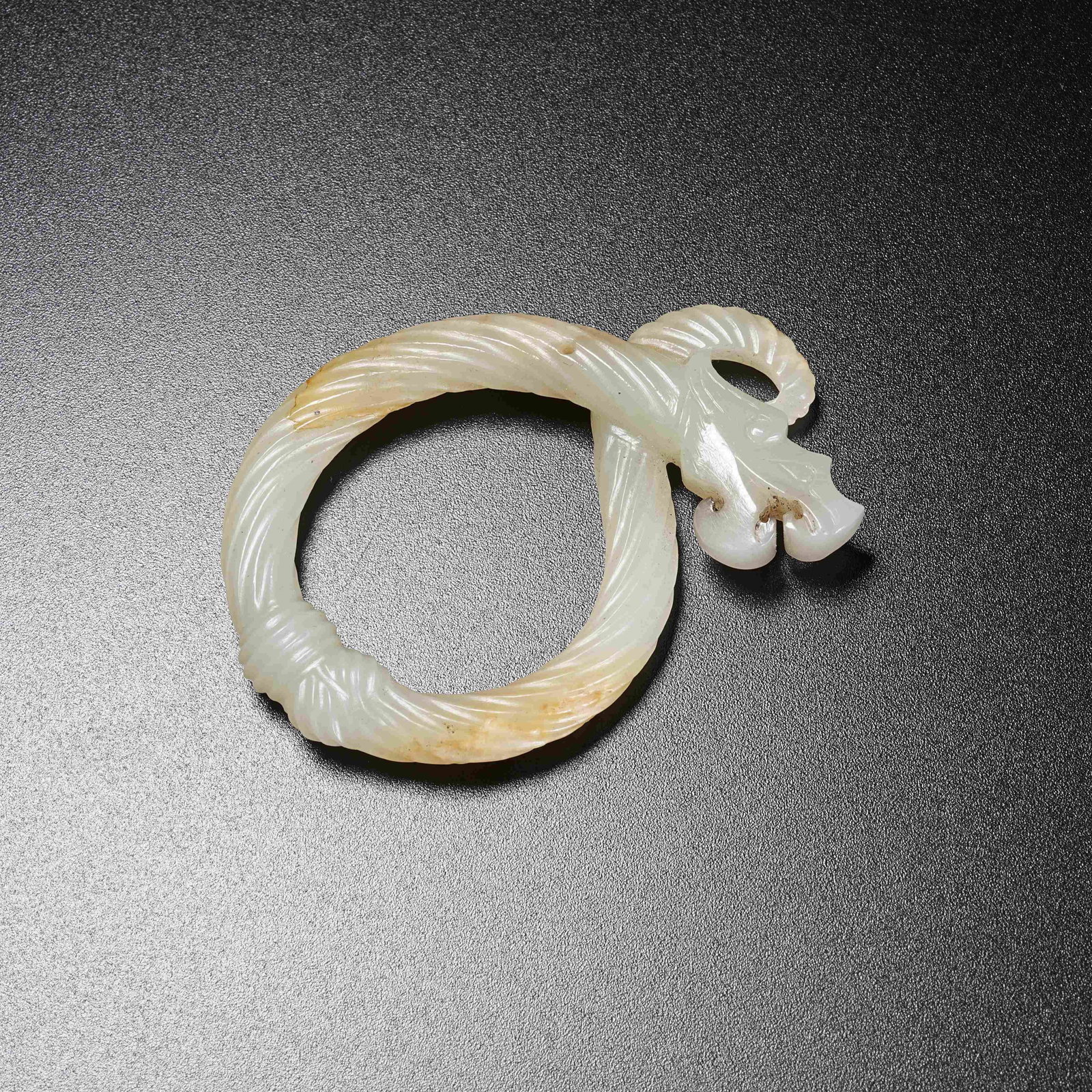 A TWISTED SILK DRAGON RING OF ANCIENT JADE: Twisted Silk Dragon Ring of Ancient Jade