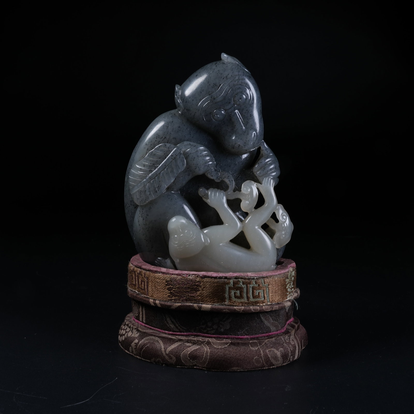 A HETIAN BLUE-AND-WHITE SEED JADE ORNAMENT OF SPIRIT MONKEY PRESENTING AUSPICIOUS BLESSINGS: Hetian Blue-and-White Seed Jade Ornament of Spirit Monkey Presenting Auspicious Blessings