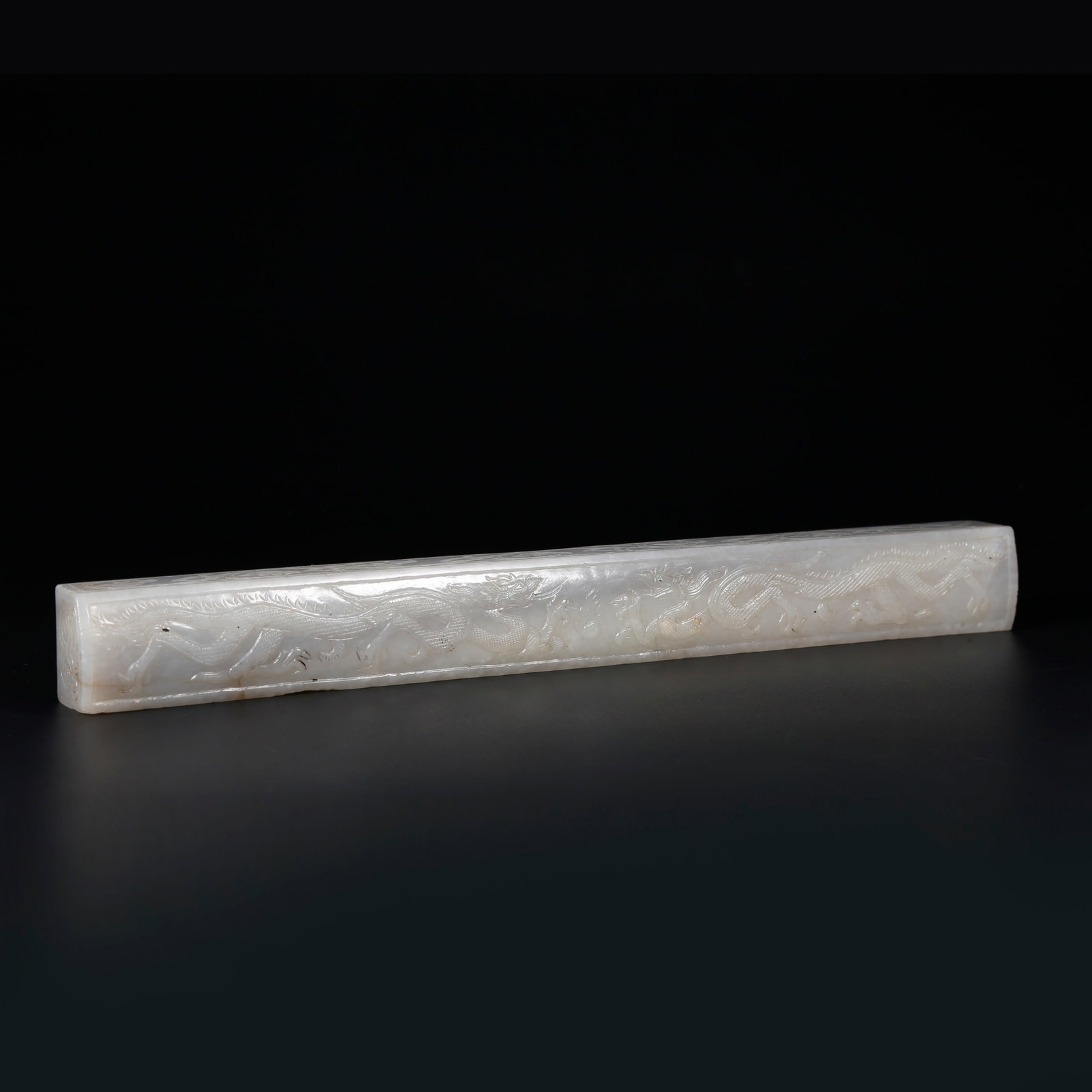 A HETIAN JADE PAPER WEIGHT CARVED WITH DRAGON PATTERNS: Hetian Jade Paper Weight Carved with Dragon Patterns