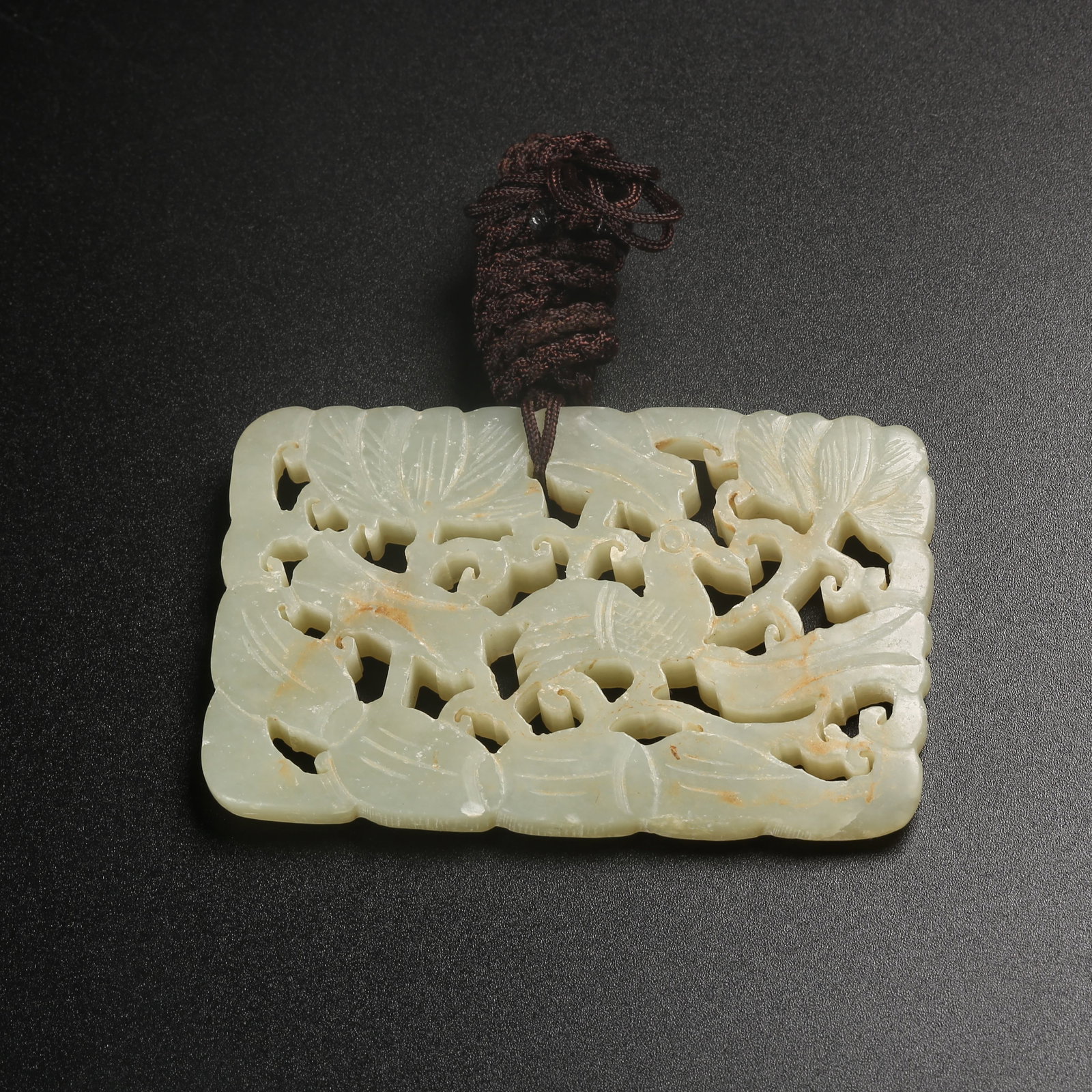 A HETIAN JADE PENDANT CARVED WITH PHOENIX MOTIFS (1 of 8)