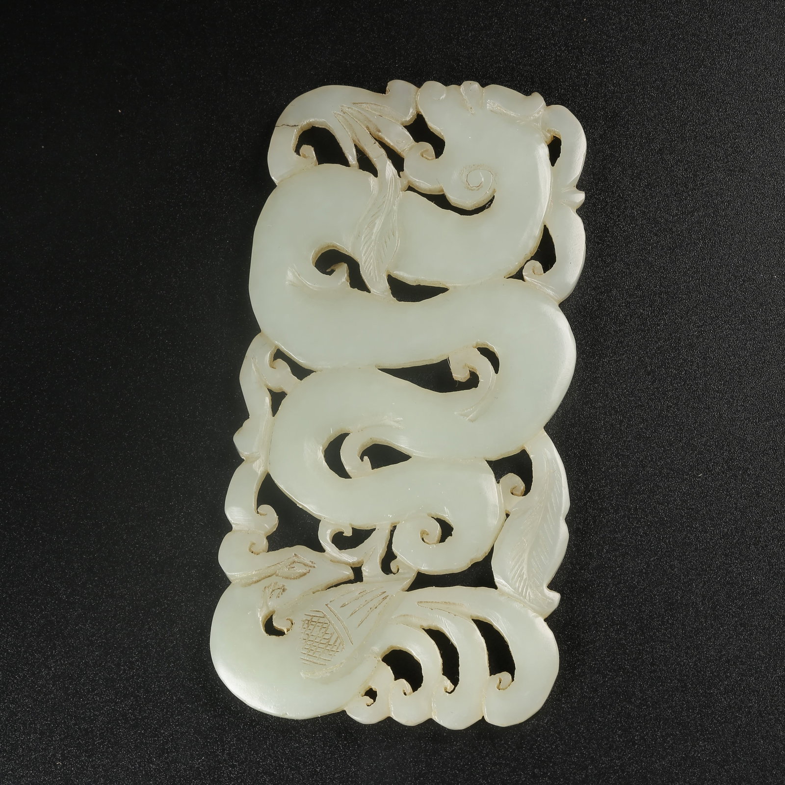A HETIAN JADE DRAGON-AND-PHOENIX PENDANT: Hetian jade dragon-and-phoenix pendant