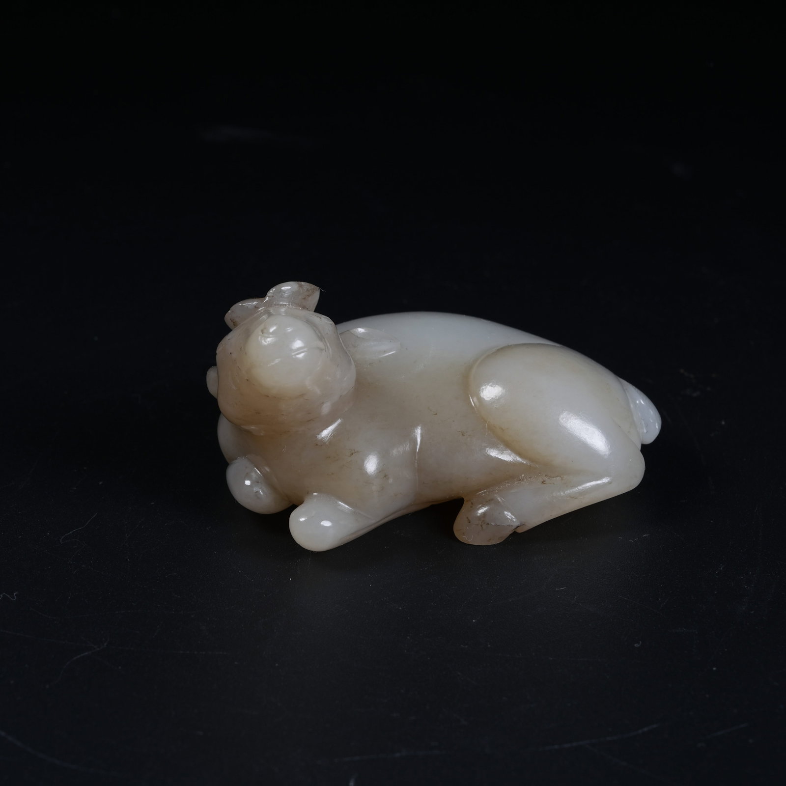 A RECUMBENT SHEEP ORNAMENT OF HETIAN JADE: Recumbent Sheep Ornament of Hetian Jade