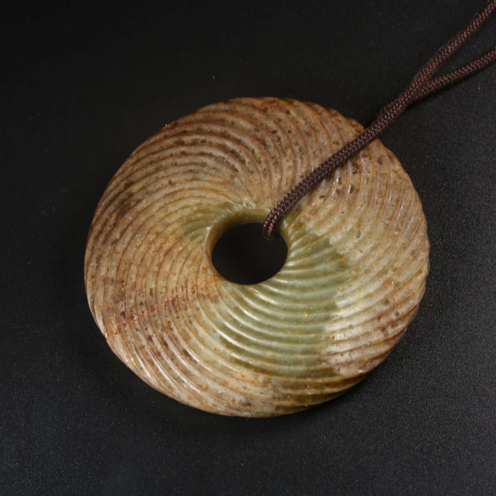 A ARCHAIC JADE TWISTED-WIRE RING: Archaic jade twisted-wire ring