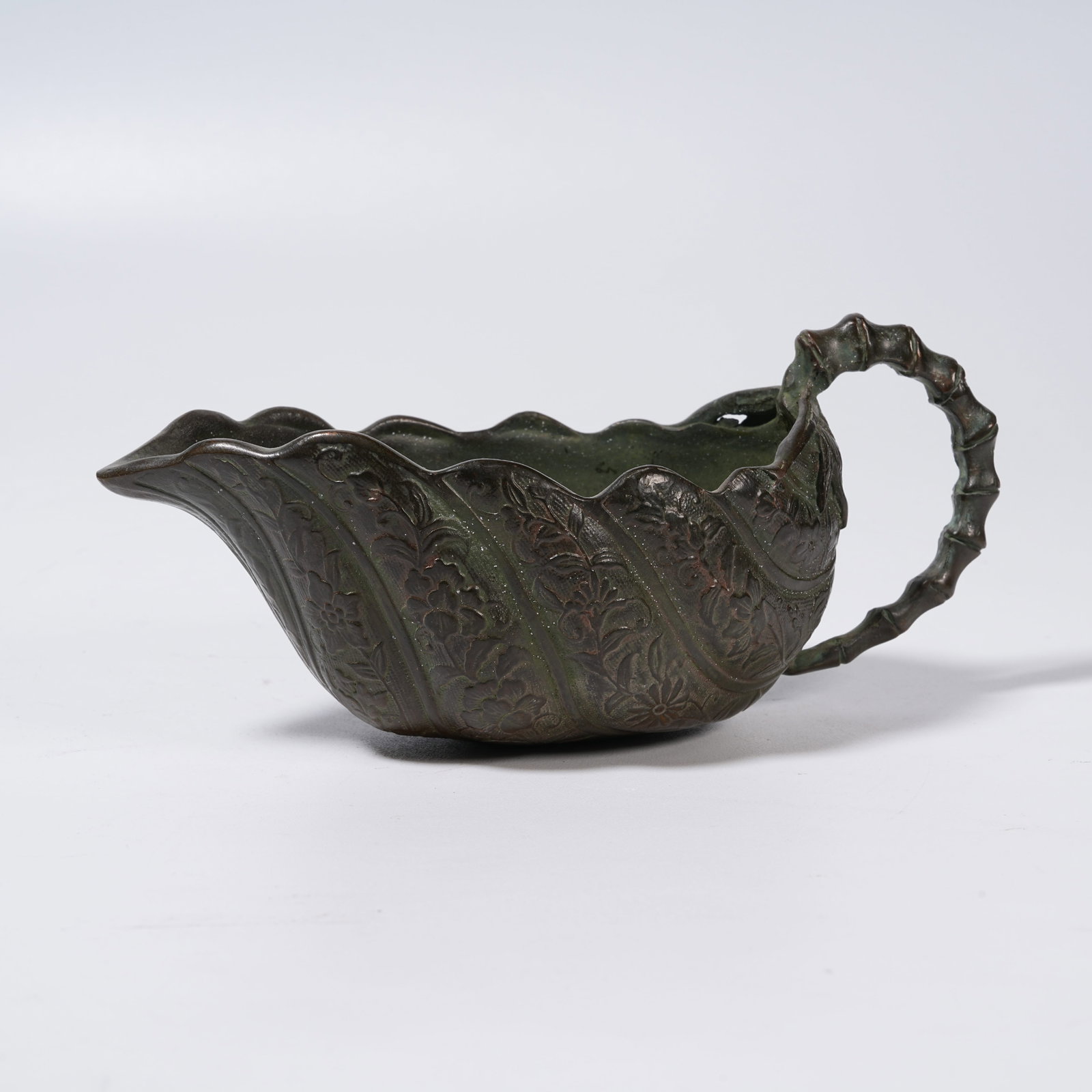 A BRONZE HANDLED CUP WITH FLORAL PATTERNS (1 of 9)