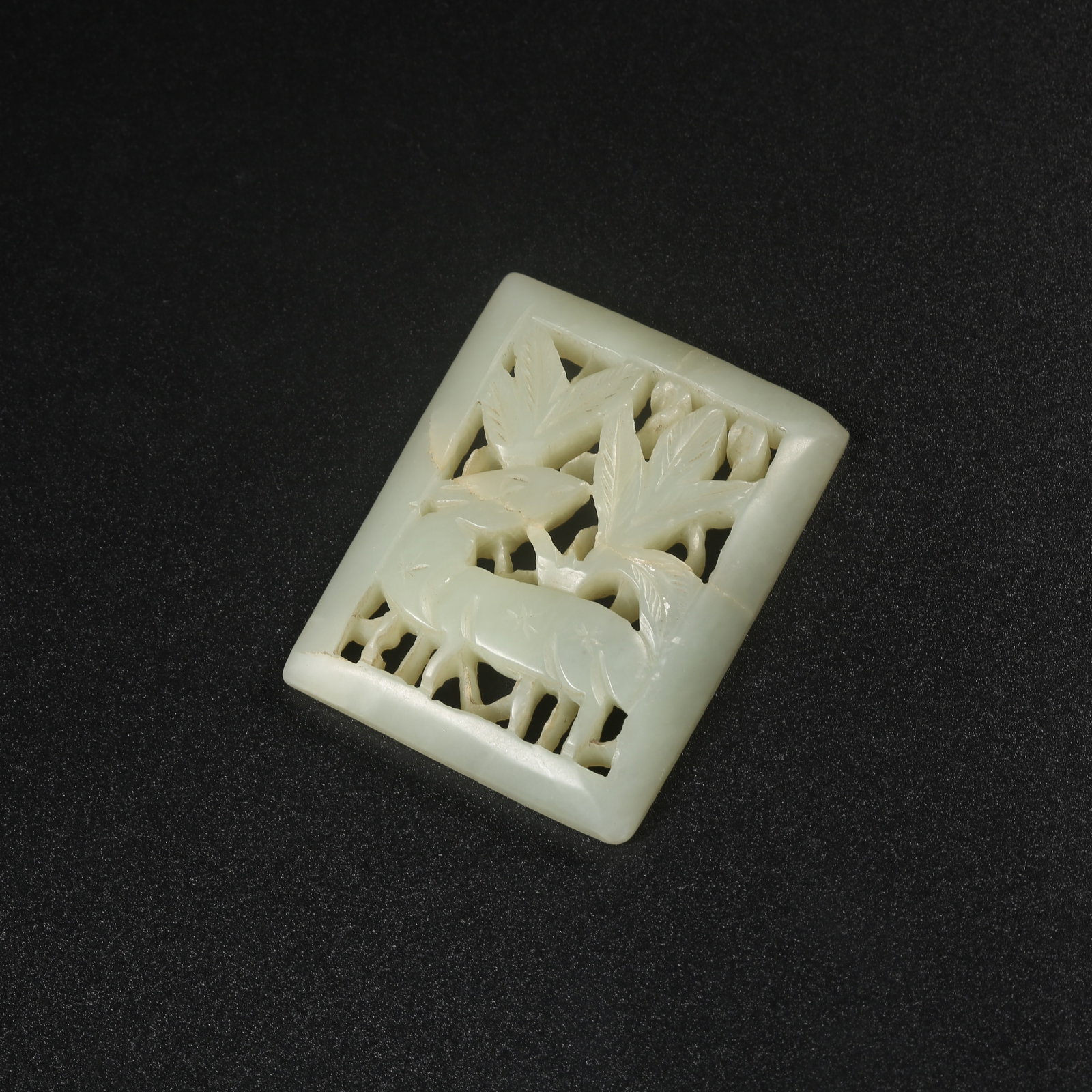A HETIAN JADE BELT ORNAMENT CARVED WITH AUSPICIOUS BEAST MOTIFS: Hetian jade belt ornament carved with auspicious beast motifs