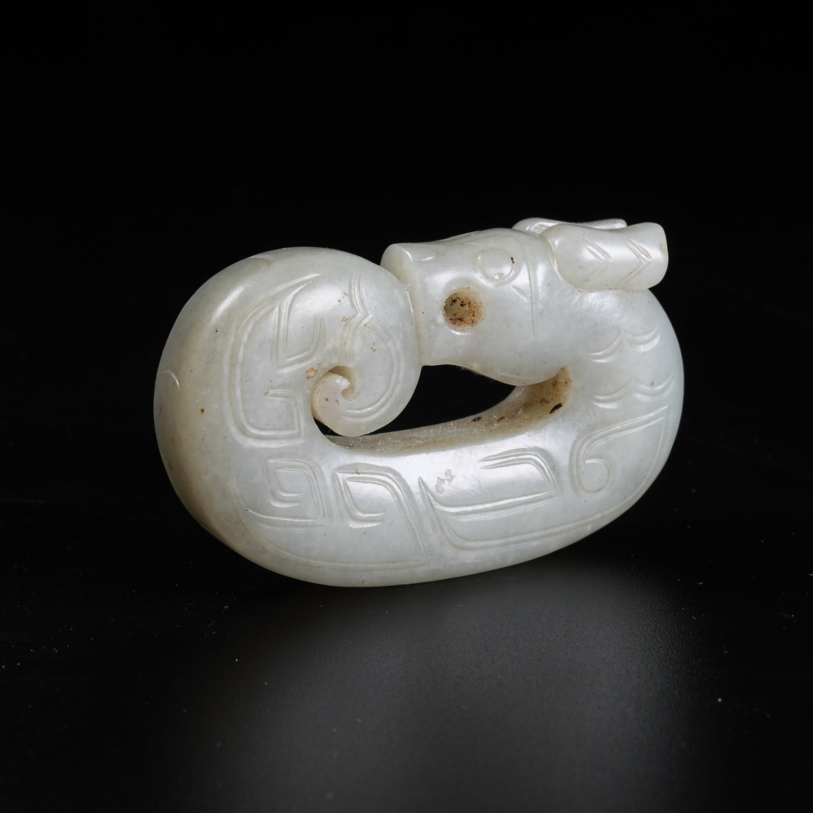 A INTERTWINED DRAGON PENDANT OF ANCIENT JADE: Intertwined Dragon Pendant of Ancient Jade
