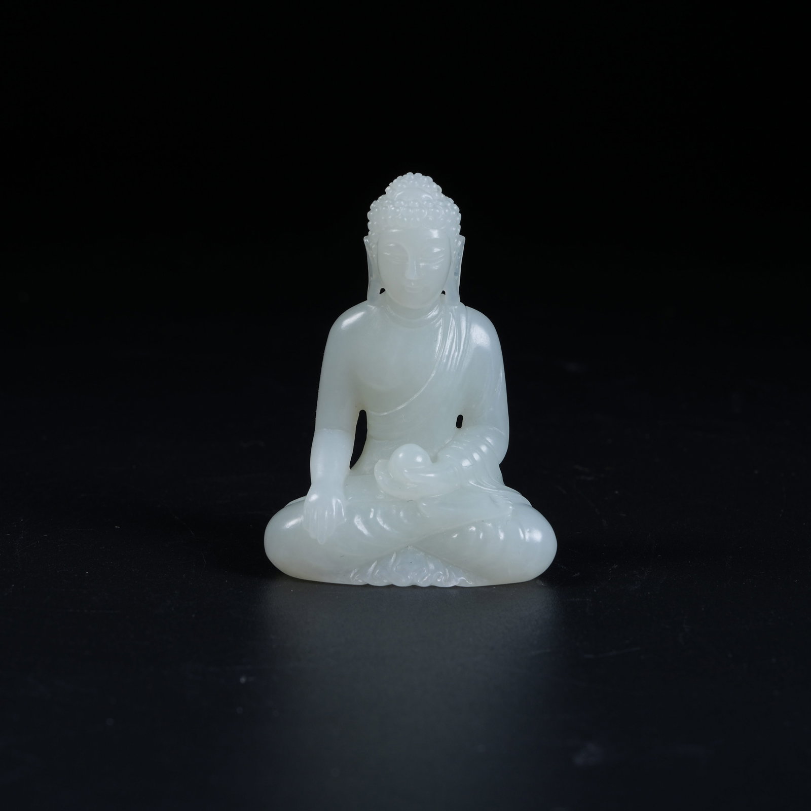 A HETIAN JADE STATUE OF SAKYAMUNI: Hetian Jade Statue of Sakyamuni