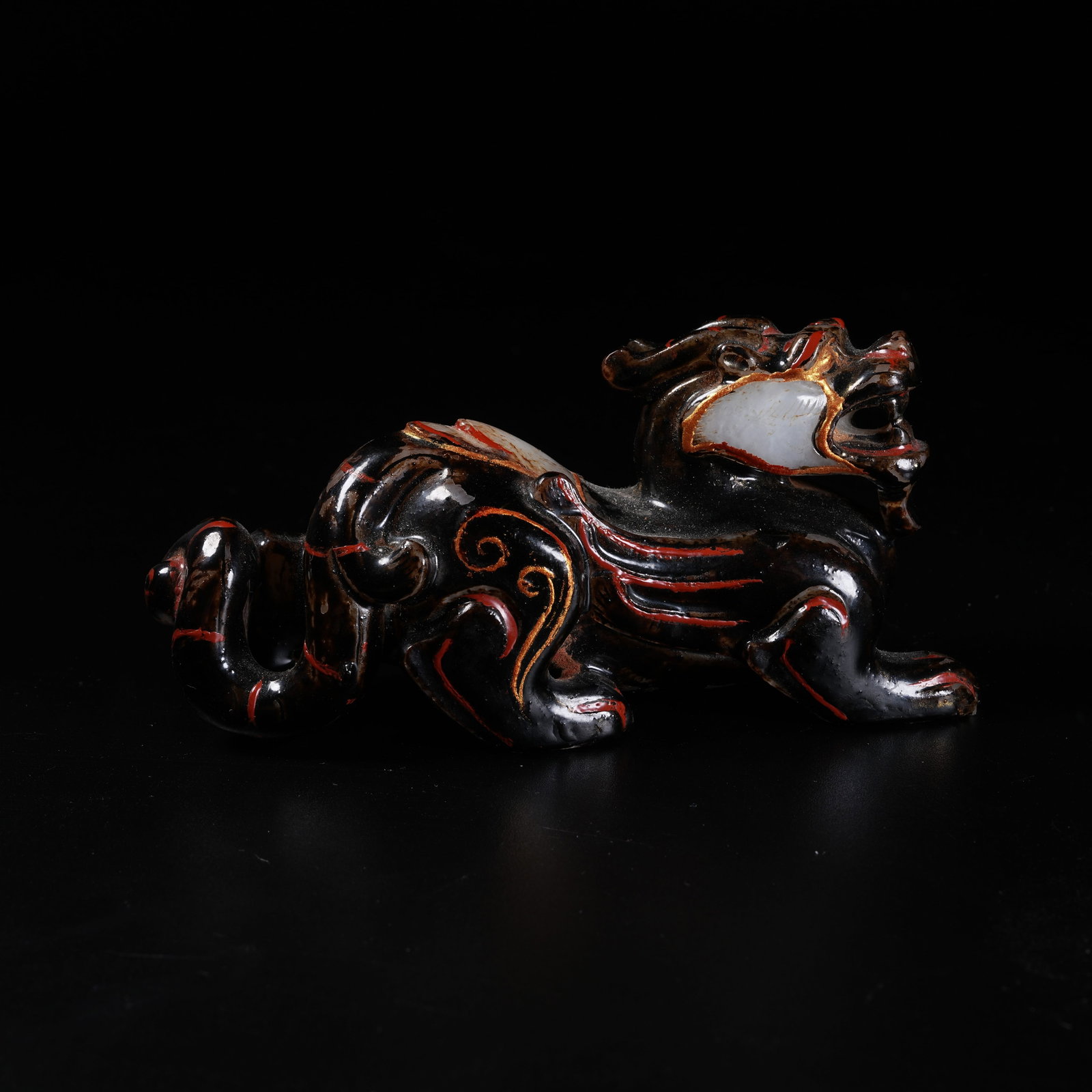 A ANCIENT JADE DIVINE BEAST ORNAMENT PAINTED WITH GOLD ON LACQUER: Ancient Jade Divine Beast Ornament Painted with Gold on Lacquer