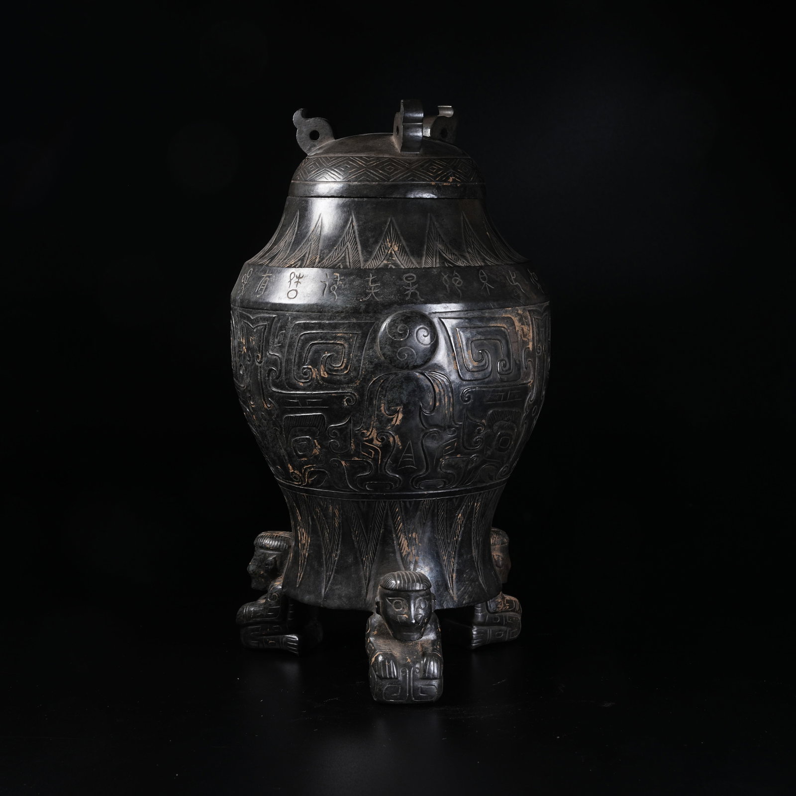 A ANCIENT JADE THREE-LOBED COVERED VESSEL WITH BEAST MASK PATTERNS AND KNEELING HUMAN LEG SUPPORTS (1 of 11)
