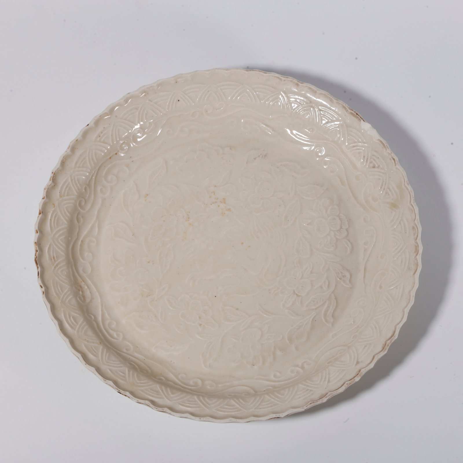 A DING KILN PLATE WITH FLORAL PATTERNS: Ding Kiln Plate with Floral Patterns