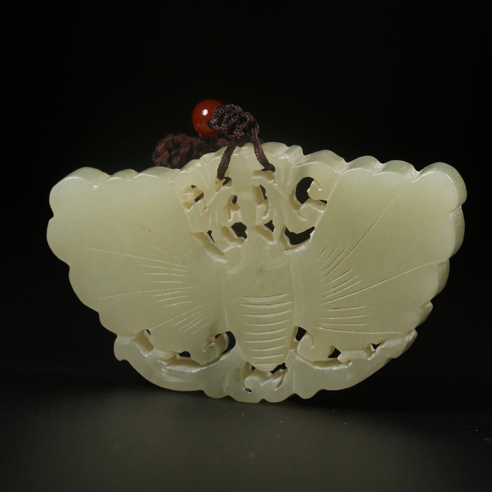 A HETIAN JADE PENDANT CARVED WITH BUTTERFLY MOTIFS: Hetian jade pendant carved with butterfly motifs