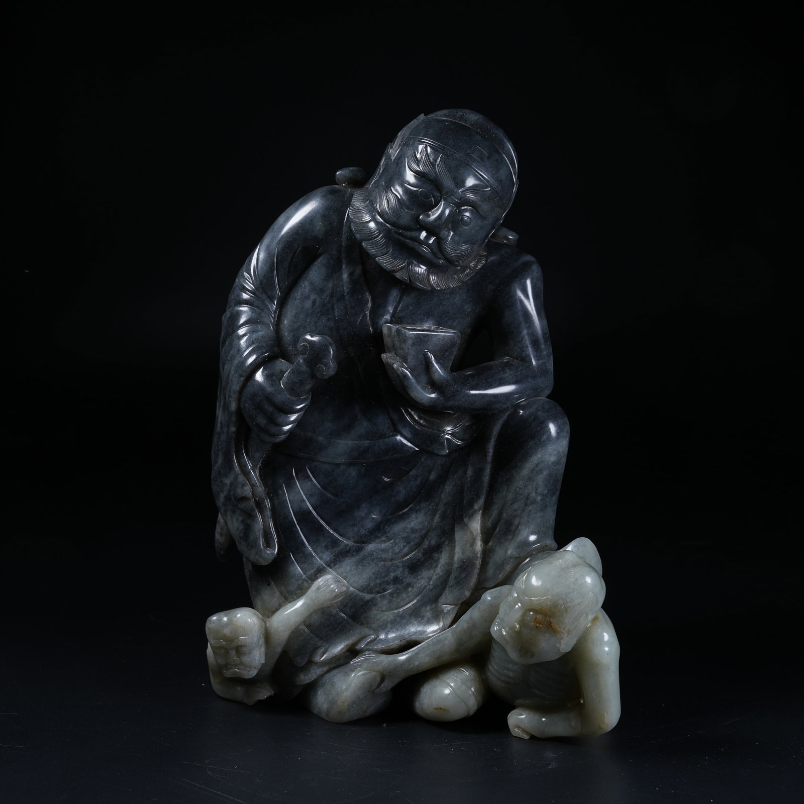 A ZHONG KUI SUBDUING DEMON ORNAMENT OF HETIAN BLUE-AND-WHITE SEED JADE: Zhong Kui Subduing Demon Ornament of Hetian Blue-and-White Seed Jade
